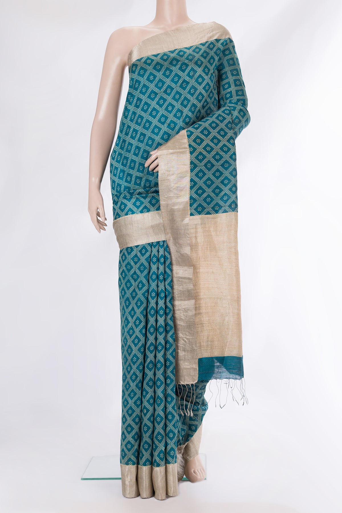 Pure Silk Teal Tussar Saree with Bandhani Print on the body and Zari Border.  displayed on a mannequin