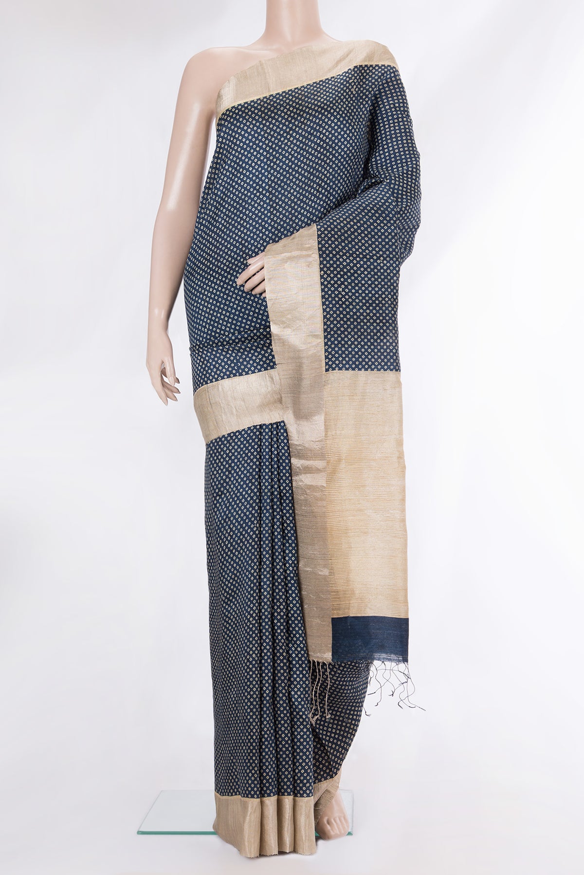 Navy Blue Tussar Saree with Bandhani Print on the body and Zari Border.  displayed on a mannequin