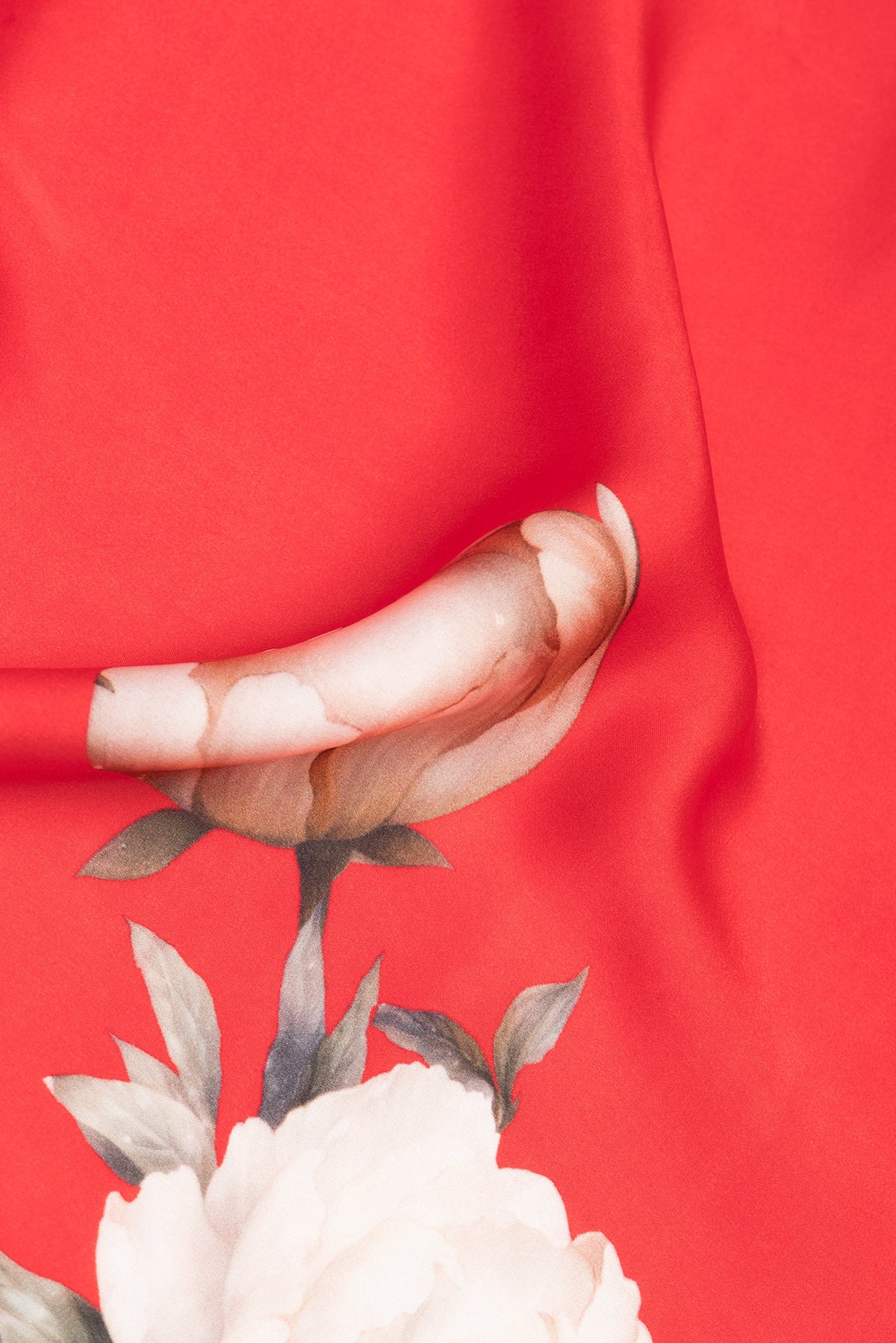 Close up of Red Crepe Saree with Floral Print on the body and Without Border.  displaying folds