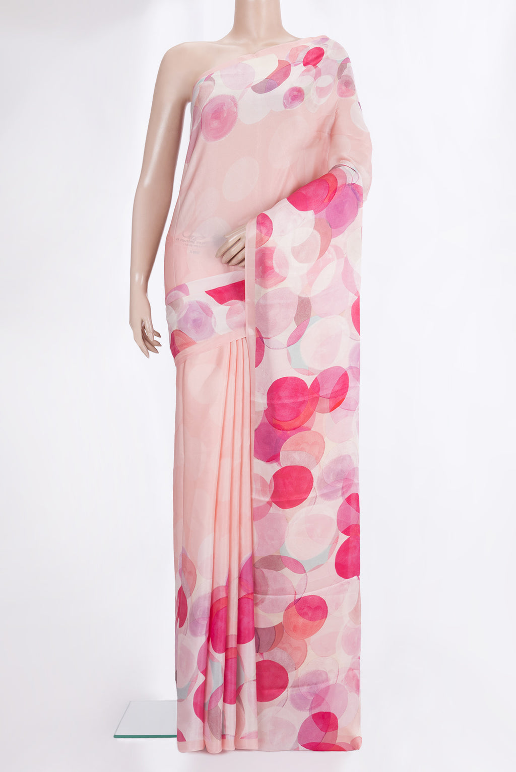 Rose Gold Crepe Saree with Floral Print on the body and Plain Border.  displayed on a mannequin