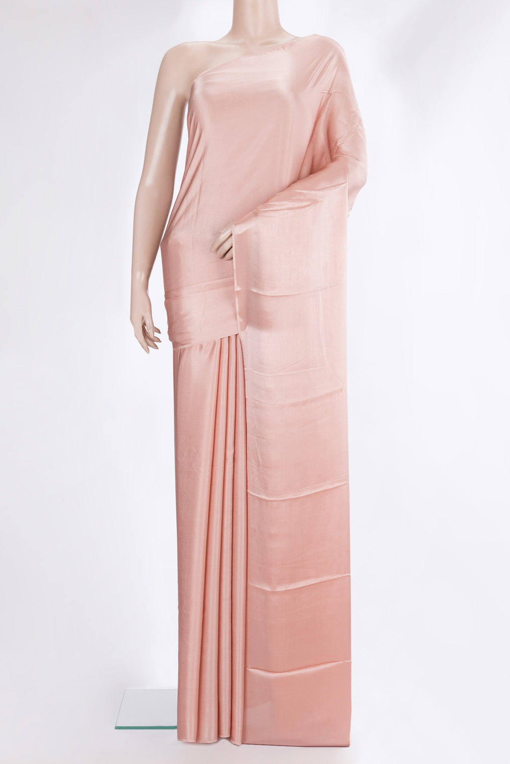 Peach Crepe Saree with Plain Body and Without Border.  displayed on a mannequin