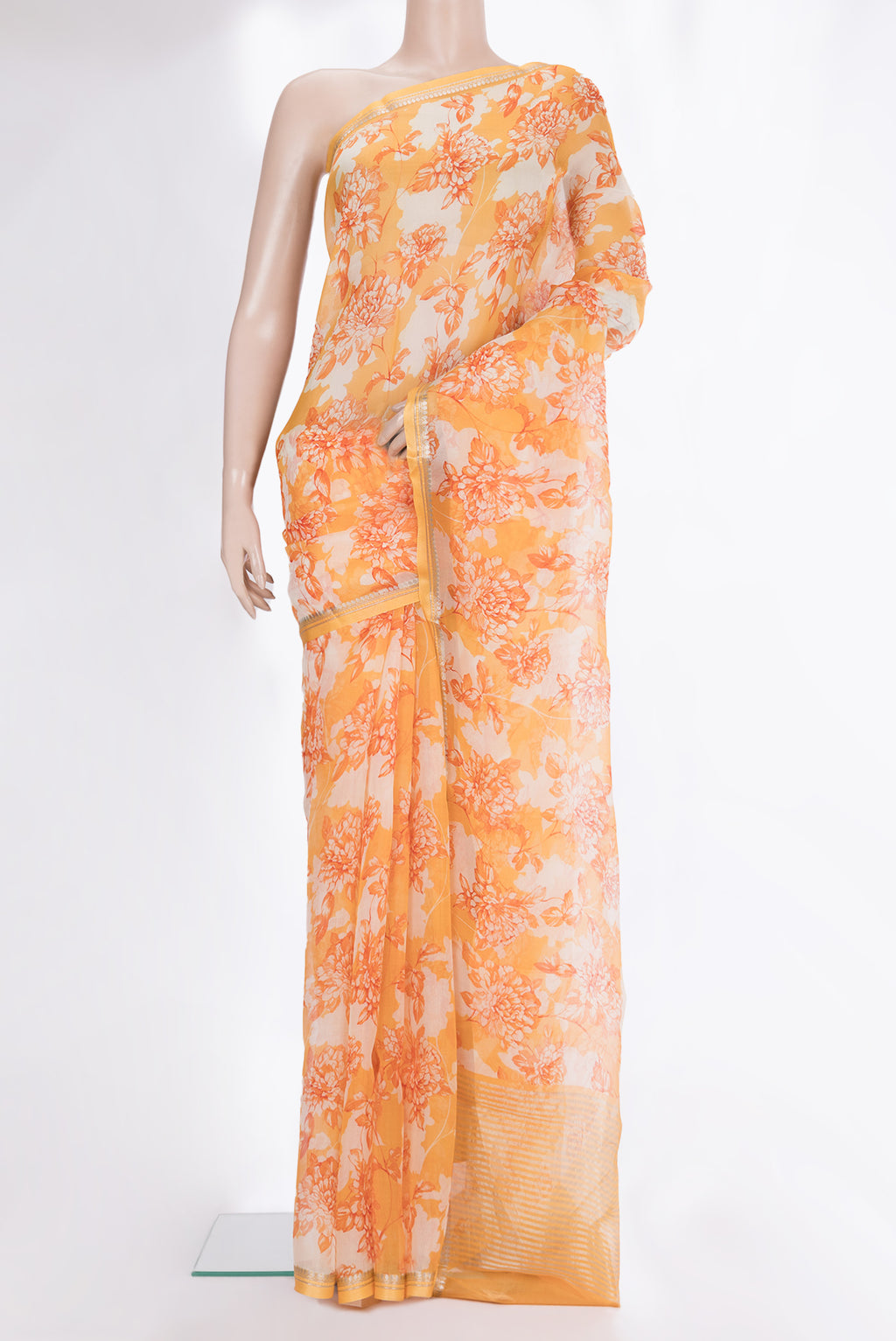 Orange Organza Saree with Floral Print on the body and Zari And Thread Border.  displayed on a mannequin