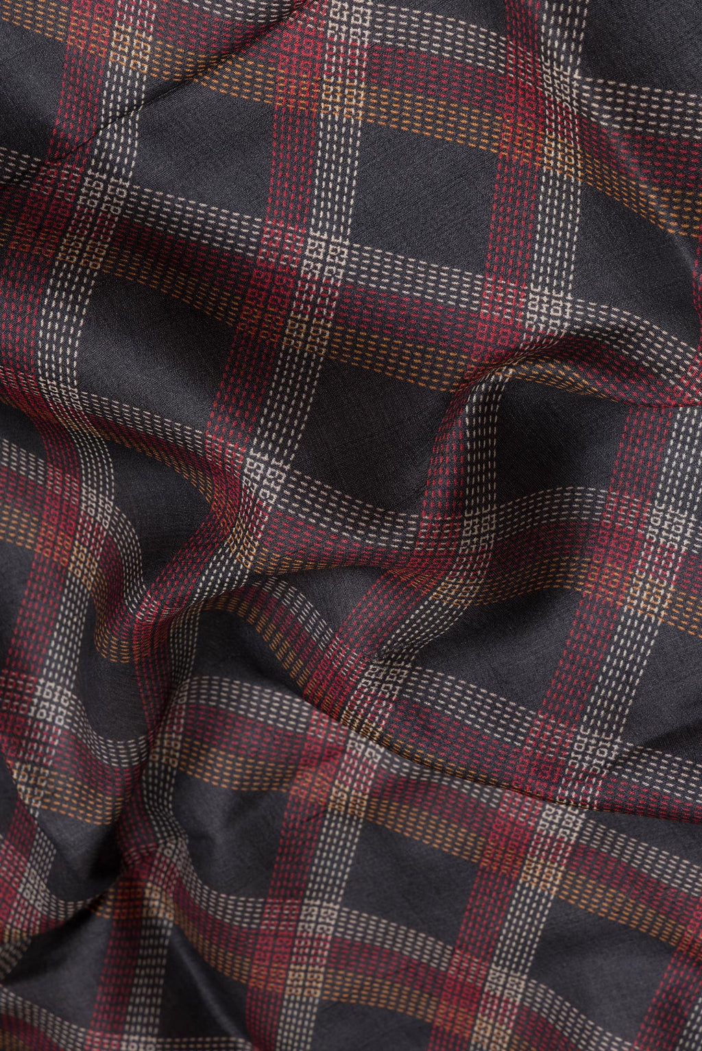 Close up of Black Tussar Silk Saree with Checked design on the body and Zari Border.  displaying folds