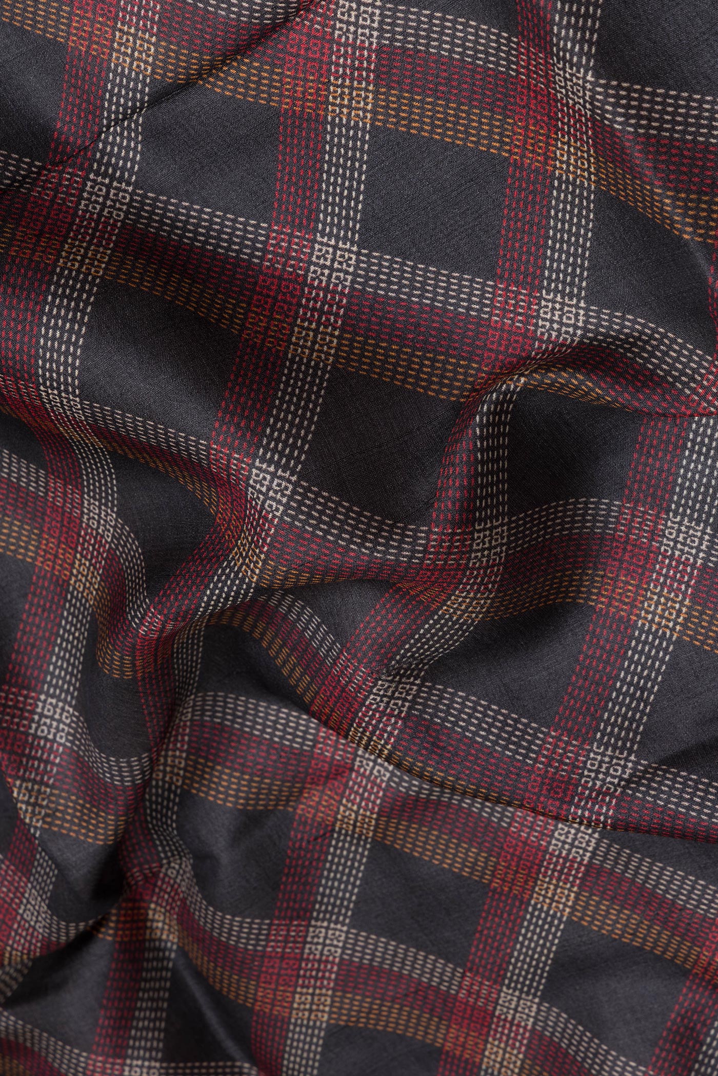 Close up of Black Tussar Silk Saree with Checked design on the body and Zari Border.  displaying folds