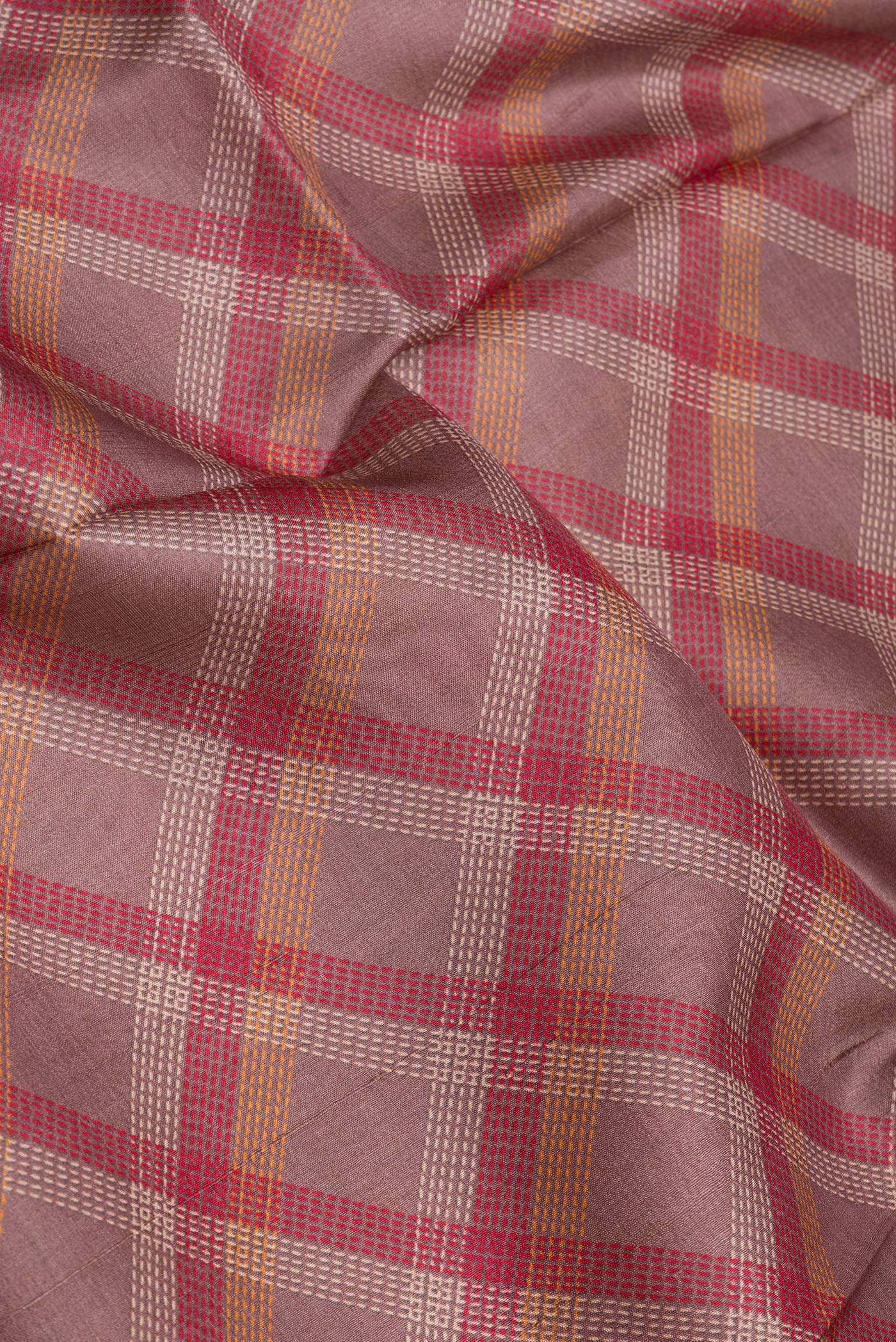 Close up of Mauve Tussar Silk Saree with Checked design on the body and Zari Border.  displaying folds
