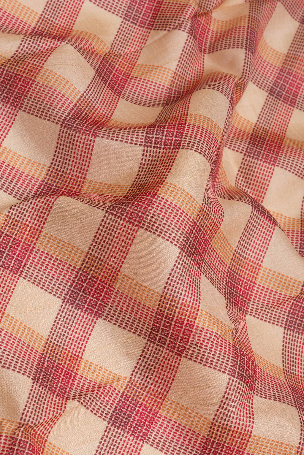 Close up of Beige Tussar Silk Saree with Checked design on the body and Zari Border.  displaying folds