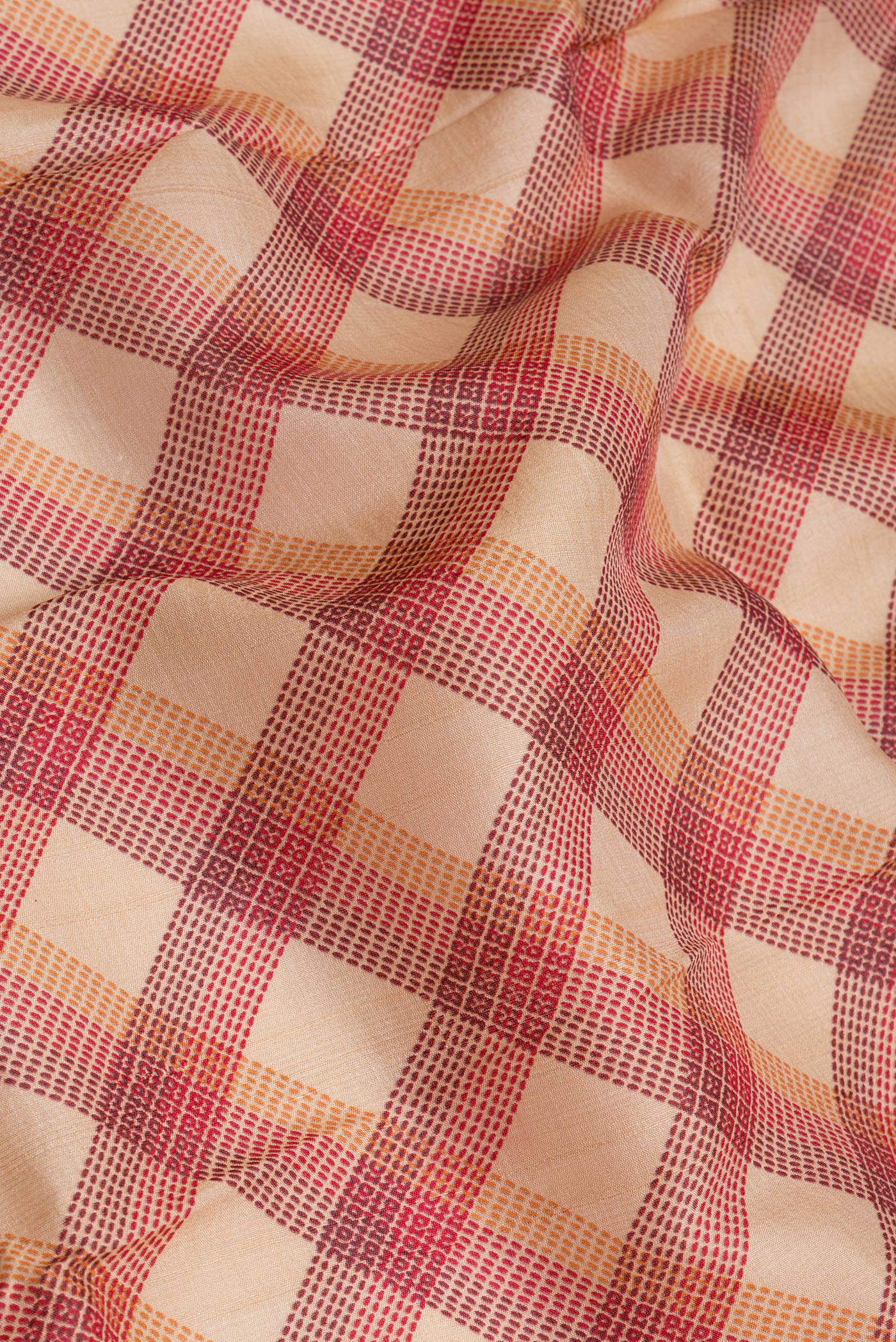 Close up of Beige Tussar Silk Saree with Checked design on the body and Zari Border.  displaying folds