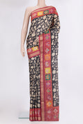 Black Tussar Saree with Printed design on the body and Zari Border.  displayed on a mannequin