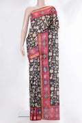 Black Tussar Saree with Printed design on the body and Fancy Border.  displayed on a mannequin