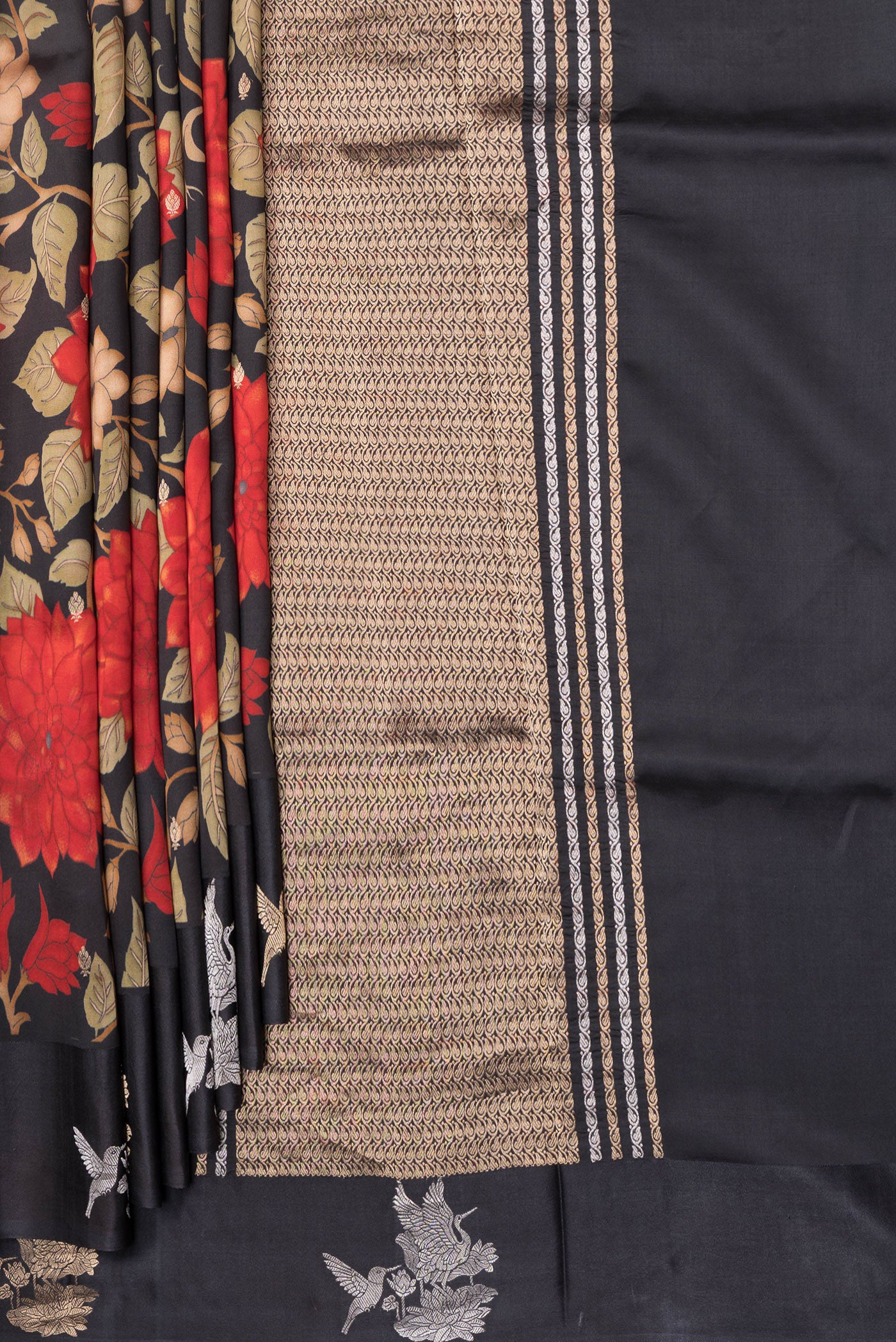 Pleats and pallu of Black Tussar Silk Saree with Floral Print on the body and Fancy Border. 