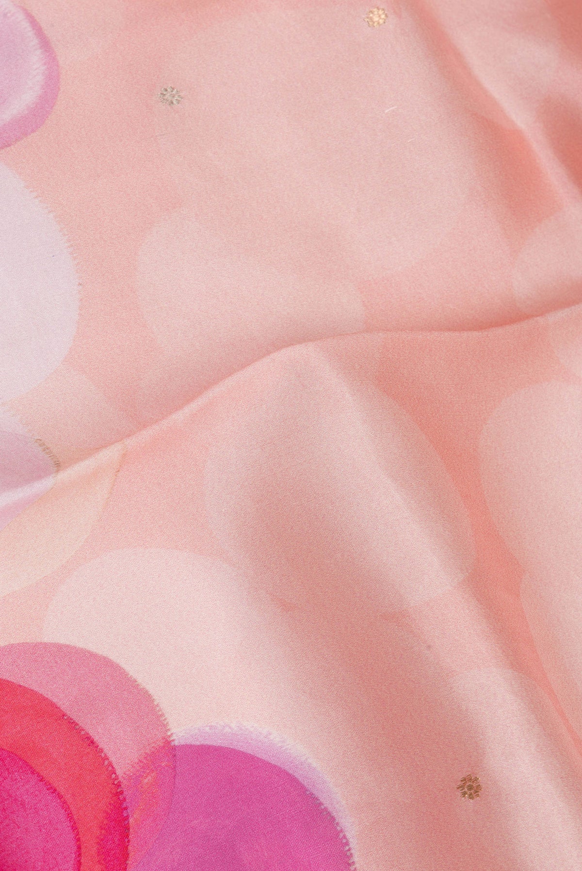 Close up of Pure Silk Peach Tussar Saree with Printed design on the body and Fancy Border.  displaying folds