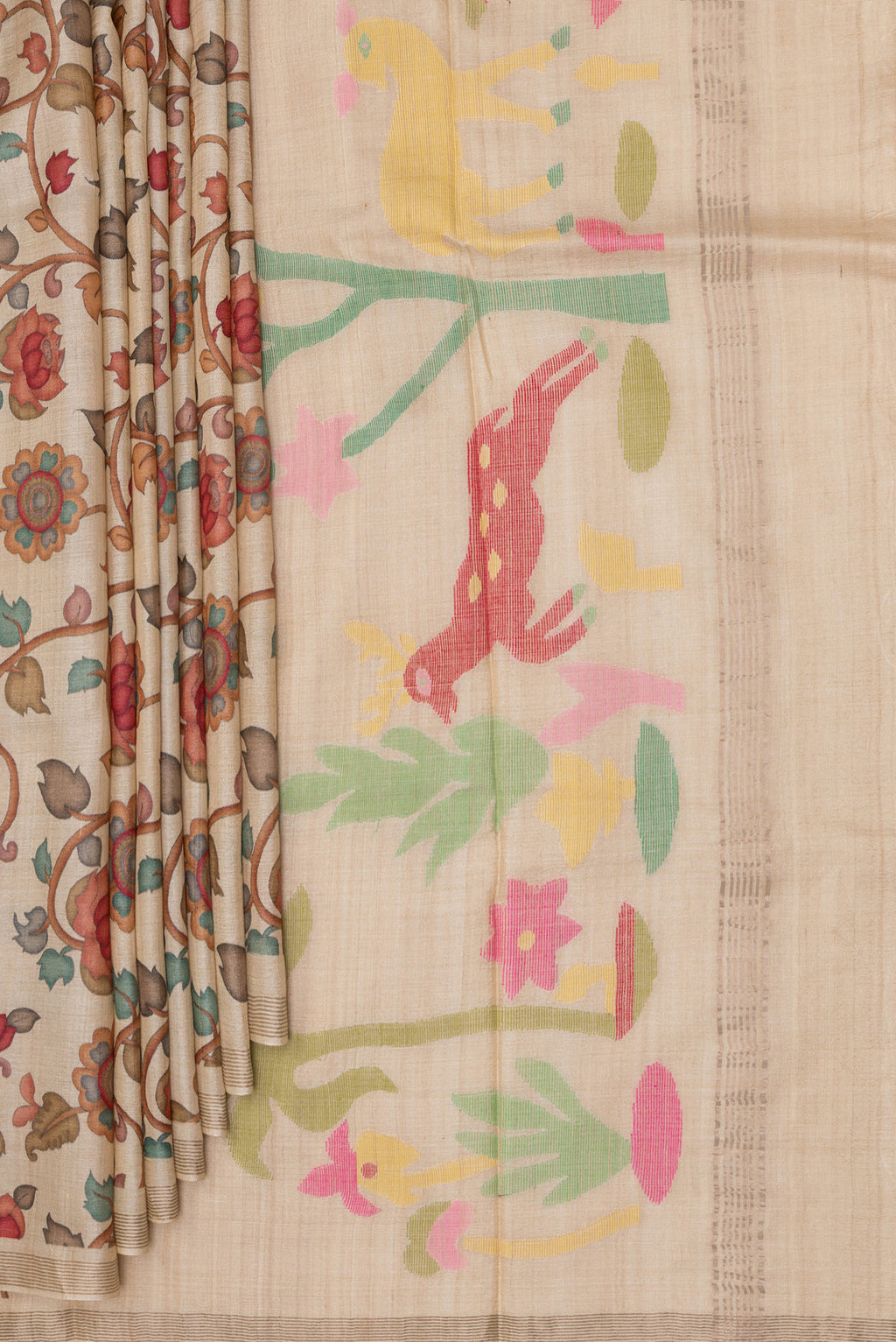Pleats and pallu of Beige Tussar Saree with Printed design on the body and Plain Border. 