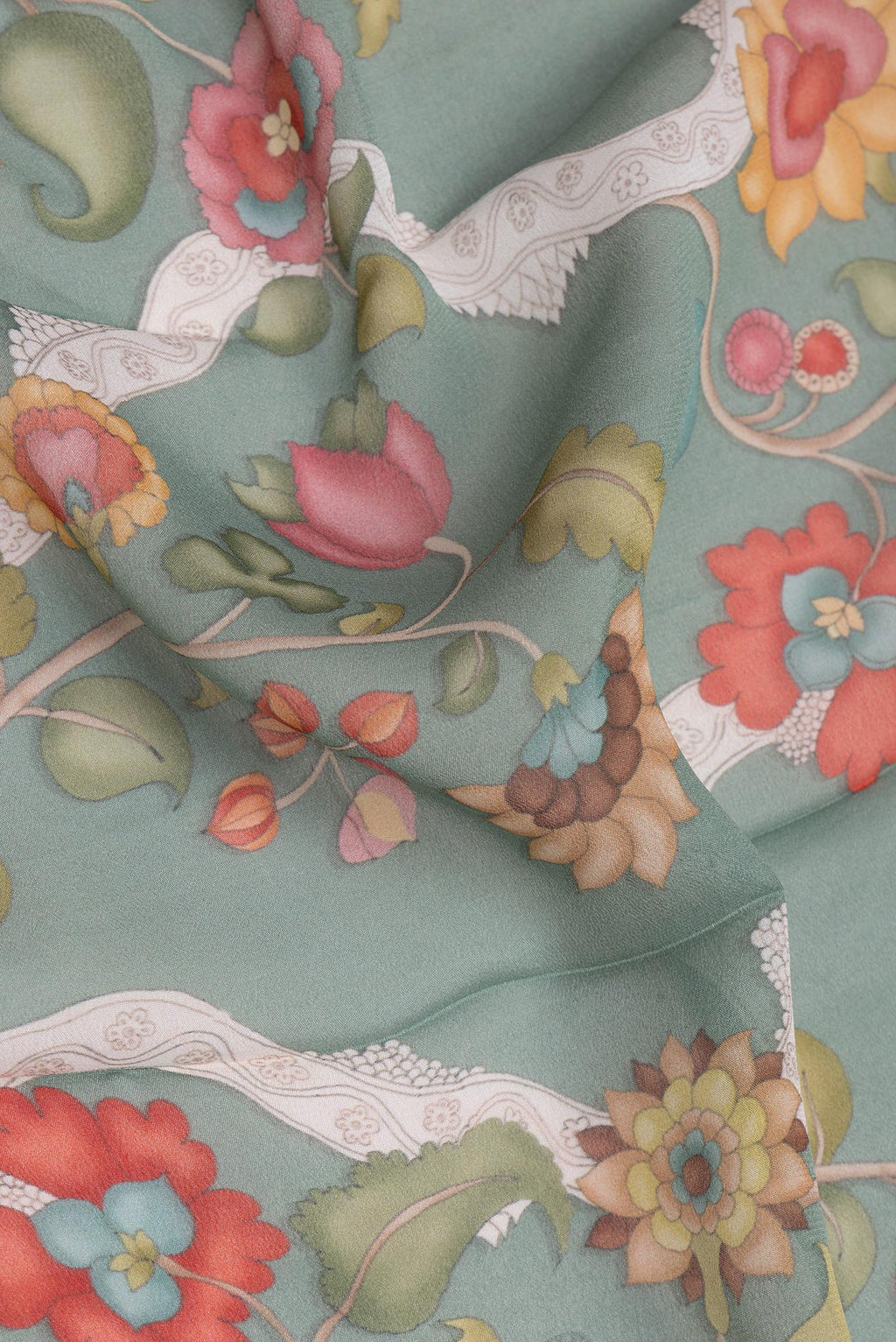 Close up of Green Georgette Saree with Printed design on the body and Zari Border.  displaying folds