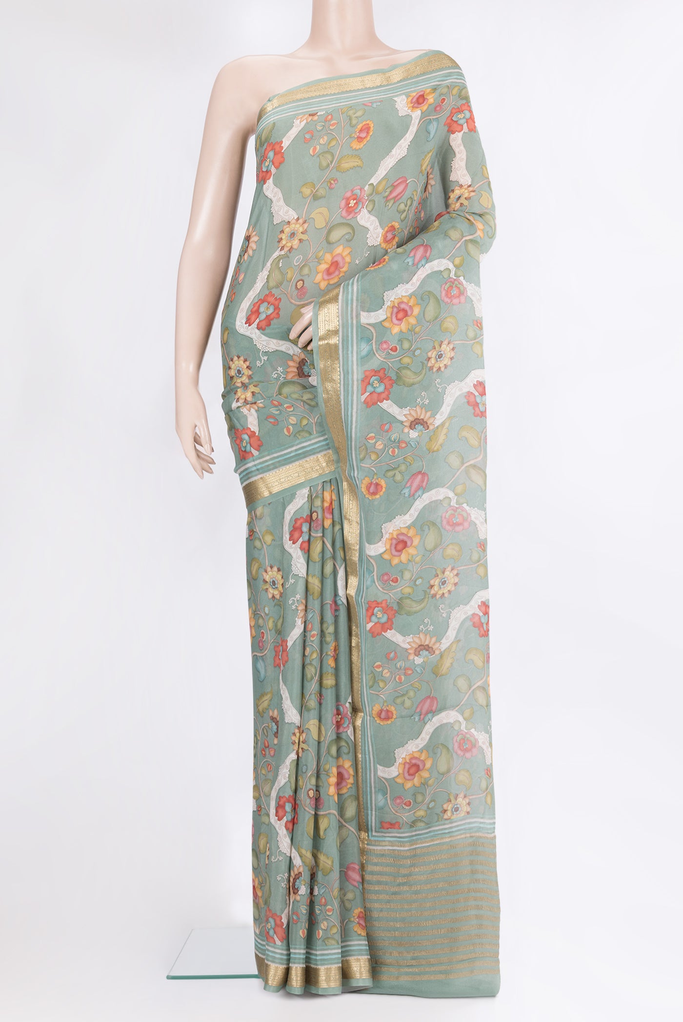 Green Georgette Saree with Printed design on the body and Zari Border.  displayed on a mannequin