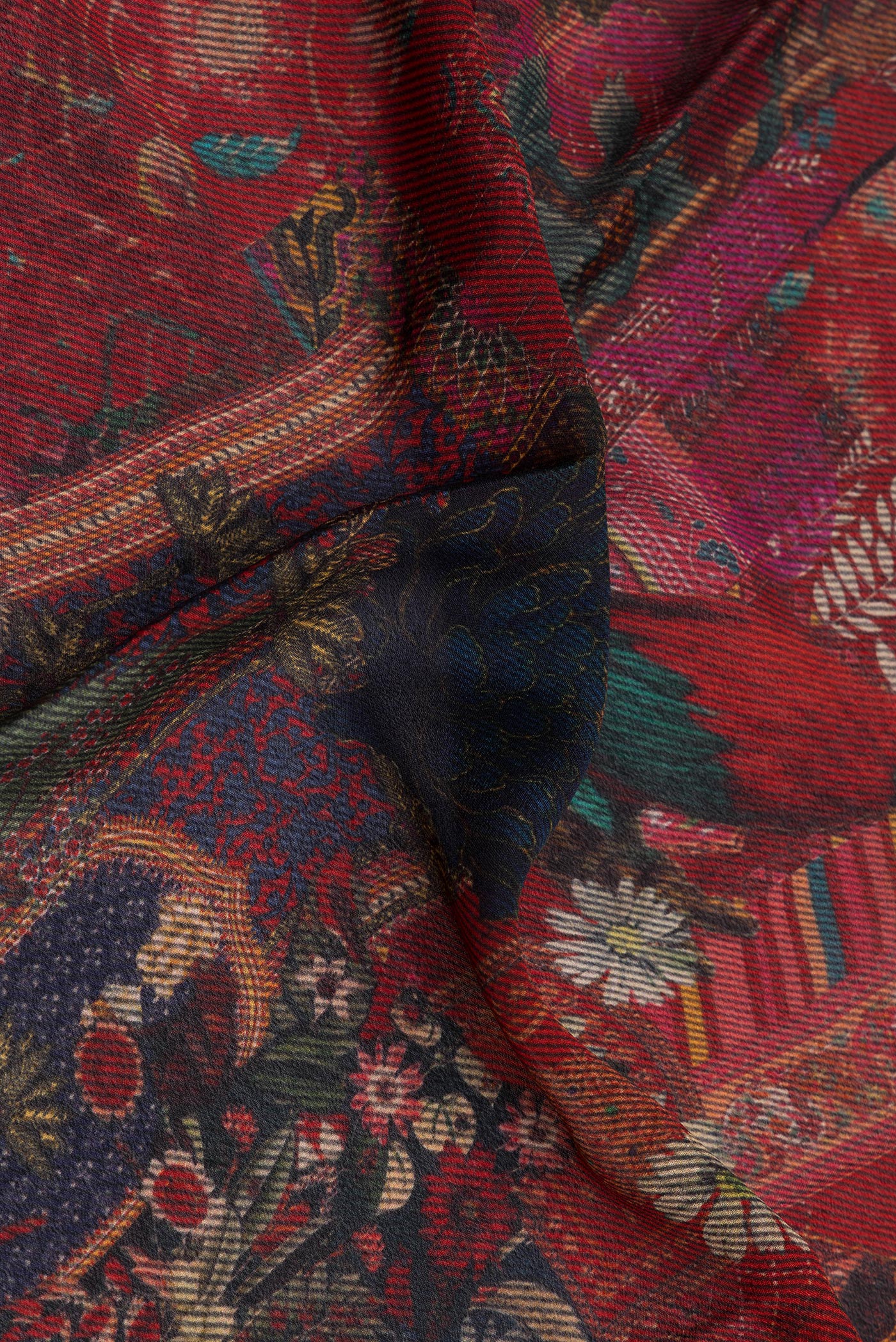 Close up of Maroon Crepe Saree with Printed design on the body and Zari Border.  displaying folds