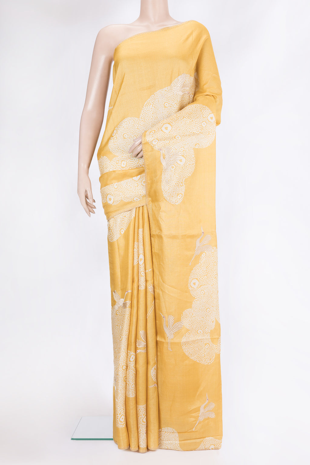 Yellow Tussar Silk Saree with Embroidery on the body and Embroidery Border.  displayed on a mannequin