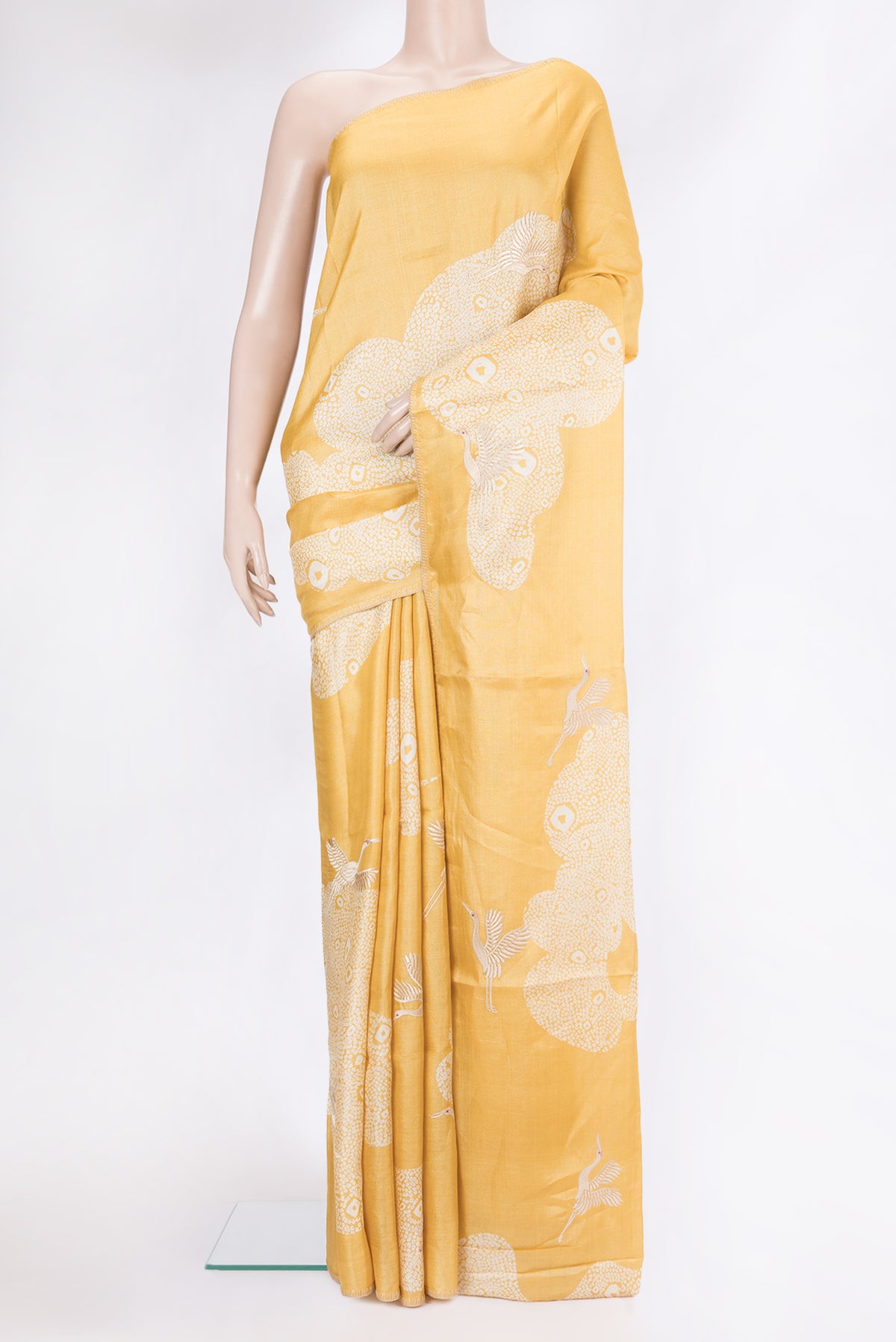 Yellow Tussar Silk Saree with Embroidery on the body and Embroidery Border.  displayed on a mannequin