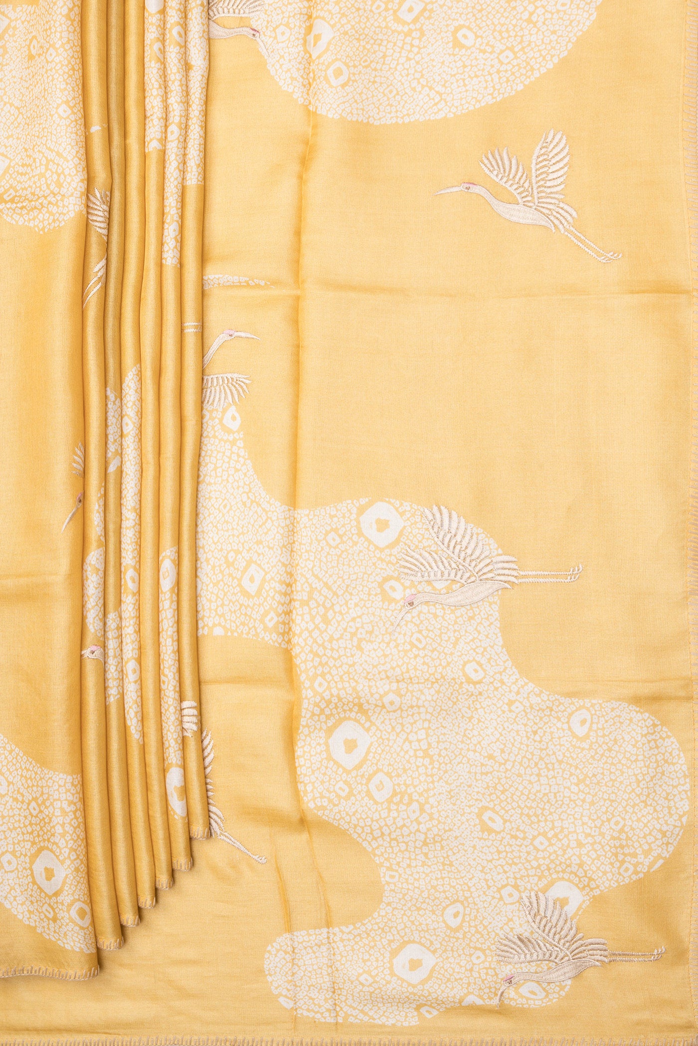 Pleats and pallu of Yellow Tussar Silk Saree with Embroidery on the body and Embroidery Border. 