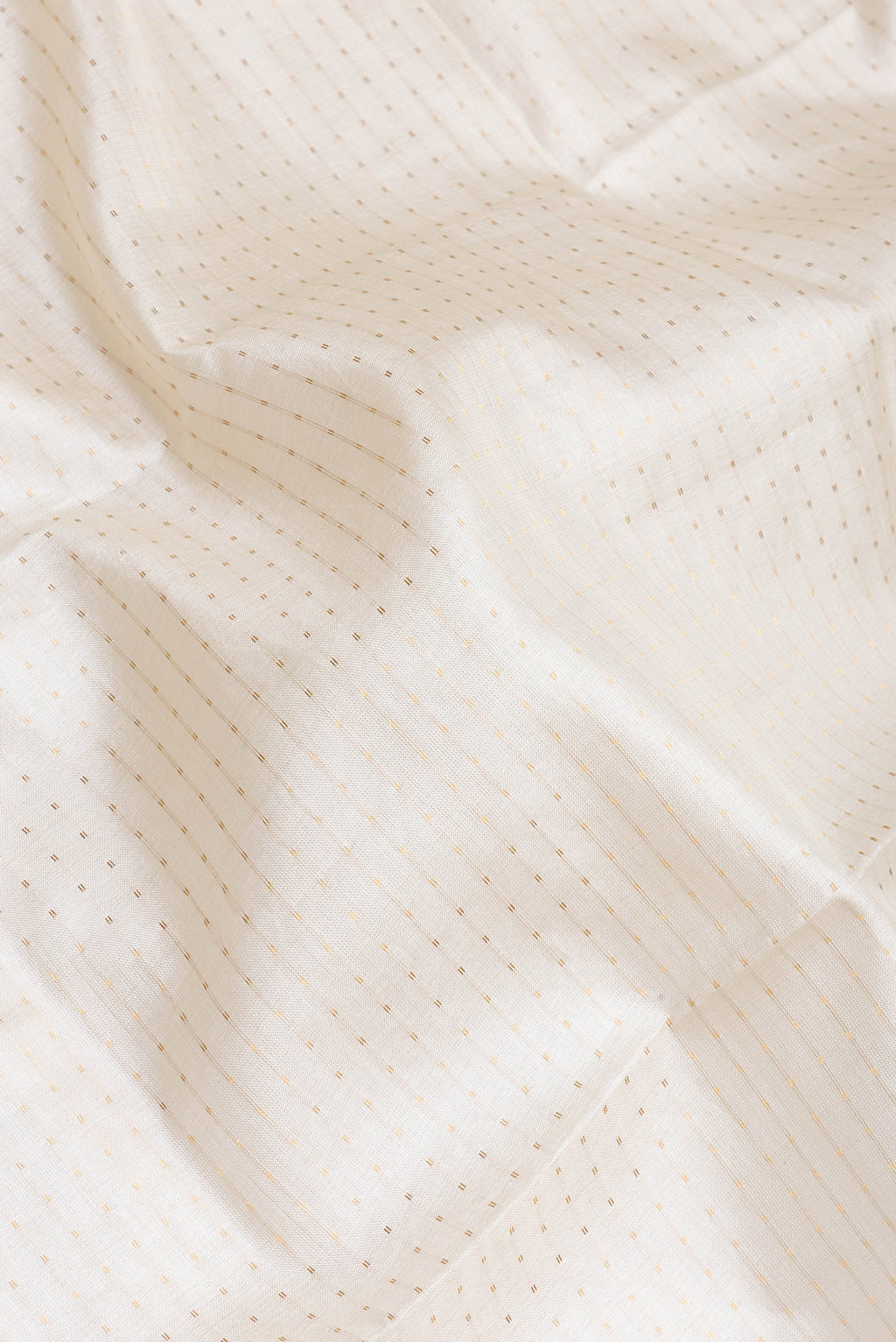 Close up of Off White Tussar Silk Saree with Stripes on the body and Fancy Border.  displaying folds