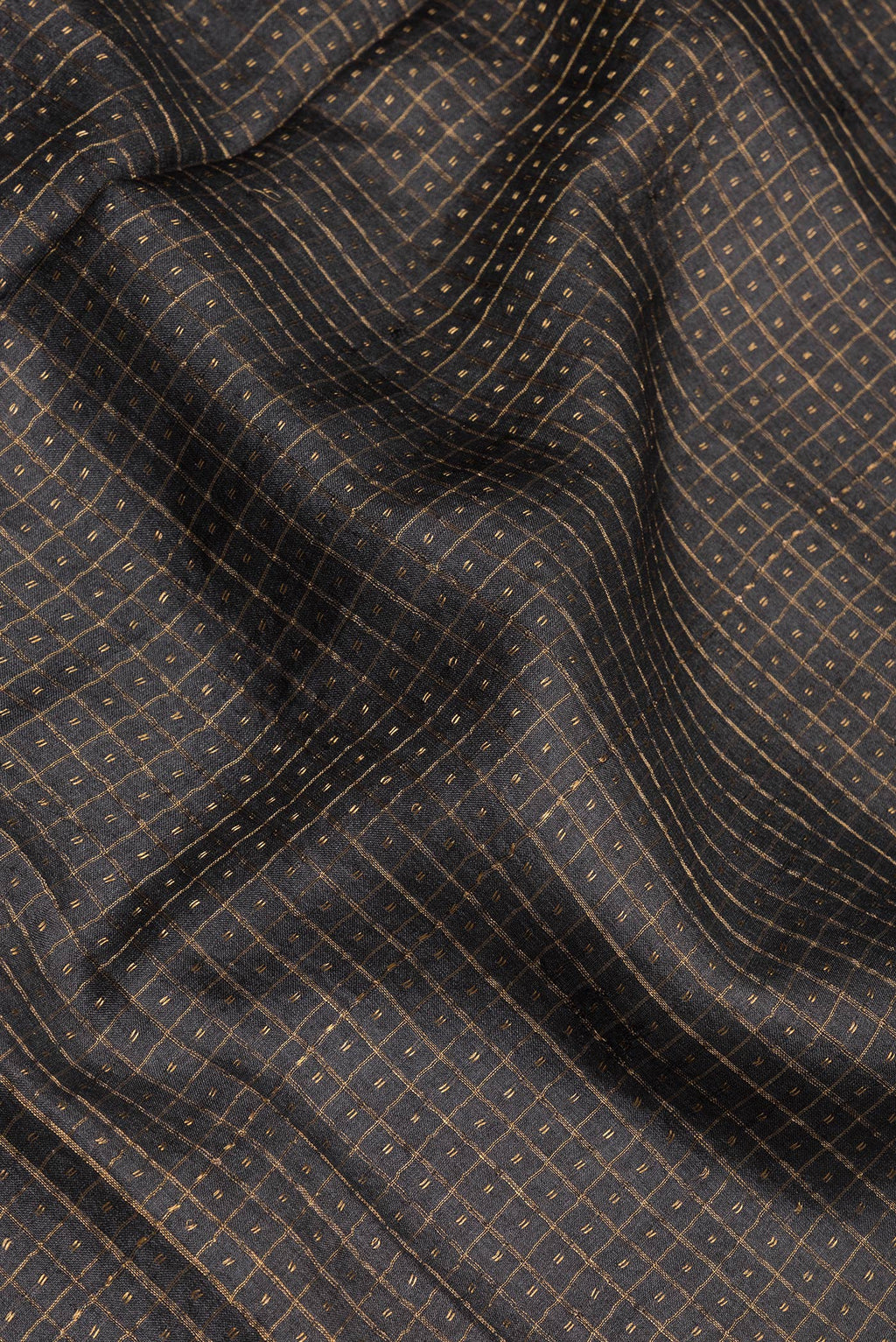 Close up of Black Tussar Silk Saree with Checked design on the body and Fancy Border.  displaying folds