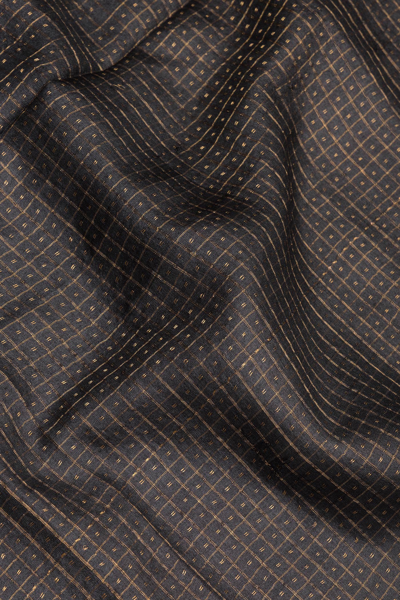 Close up of Black Tussar Silk Saree with Checked design on the body and Fancy Border.  displaying folds