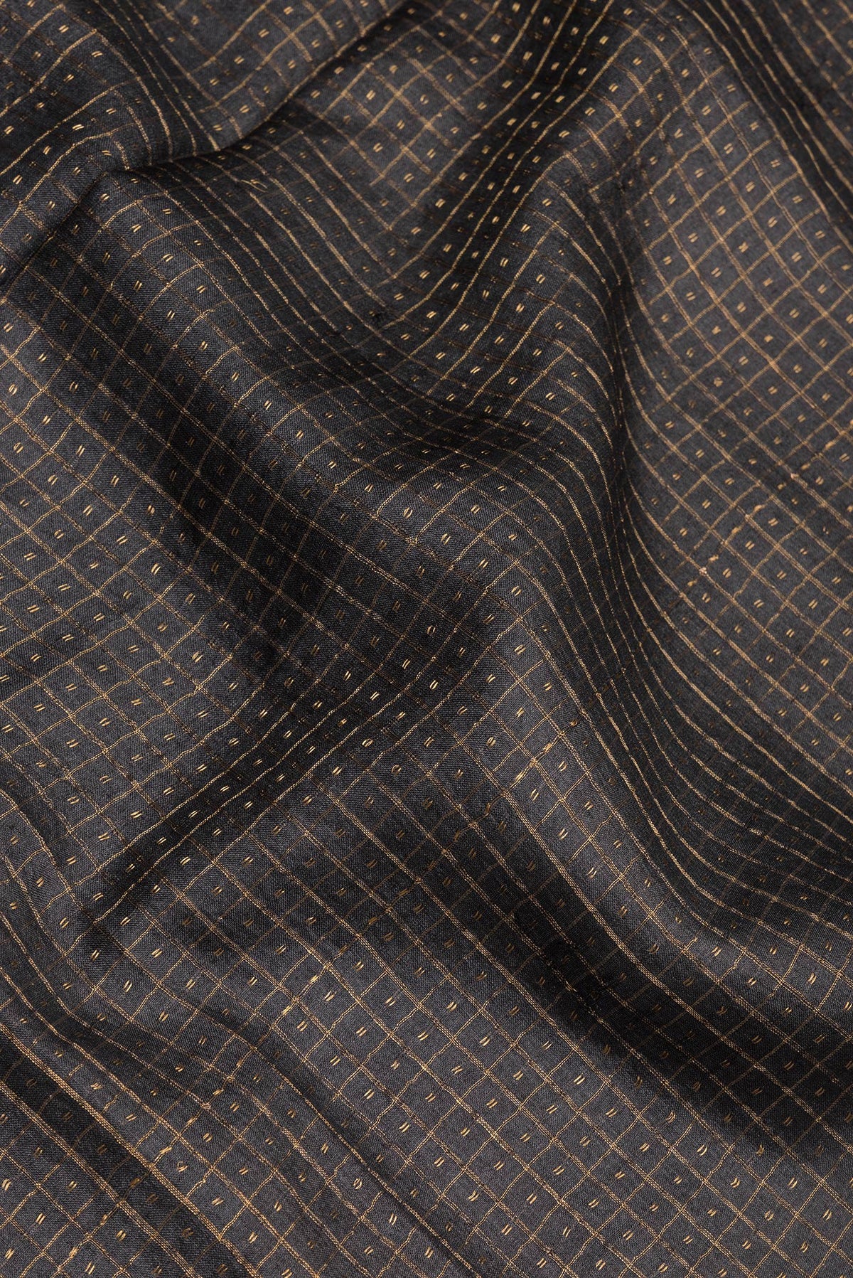 Close up of Black Tussar Silk Saree with Checked design on the body and Fancy Border.  displaying folds