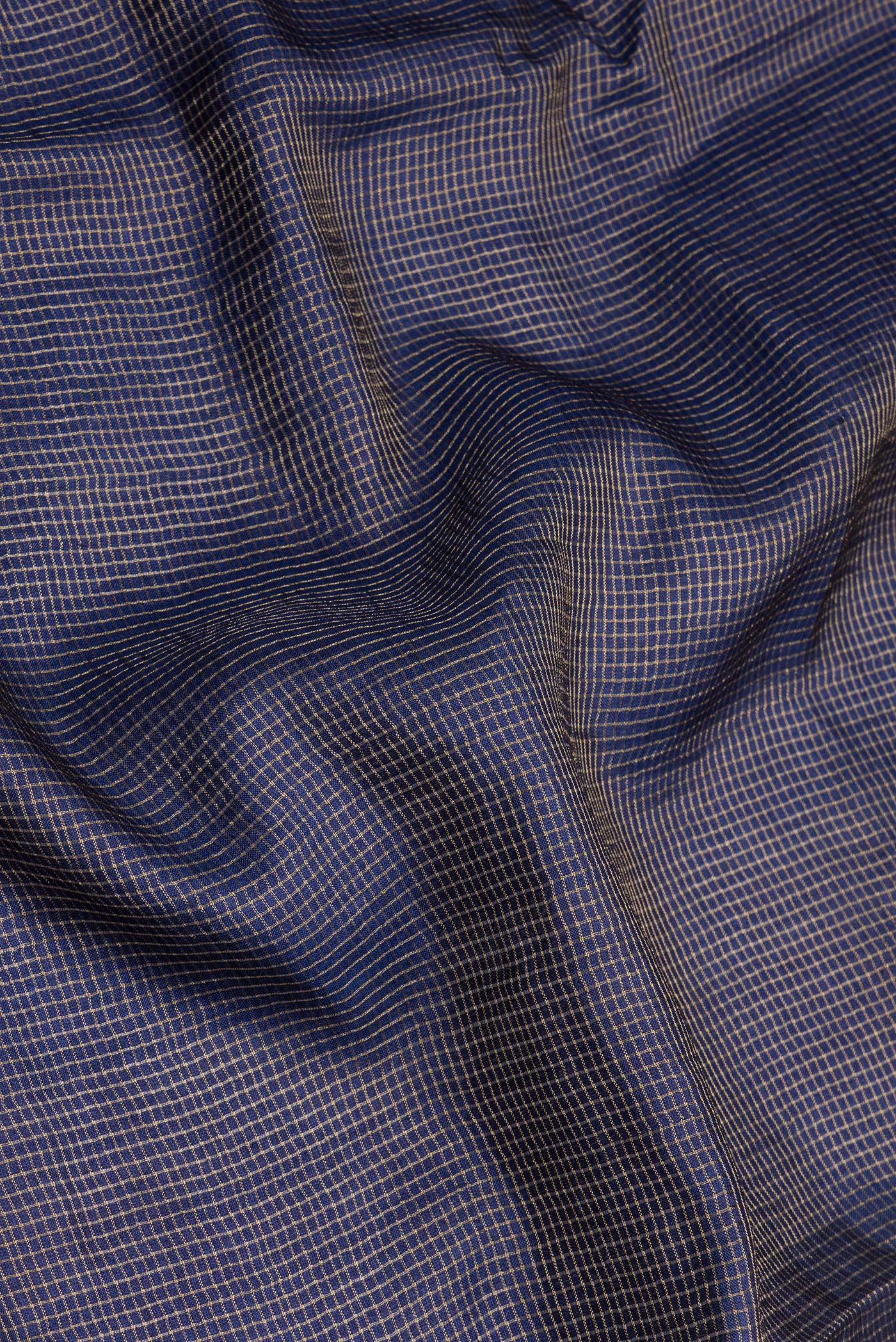 Close up of Navy Blue Tussar Silk Saree with Checked design on the body and Embroidery Border.  displaying folds