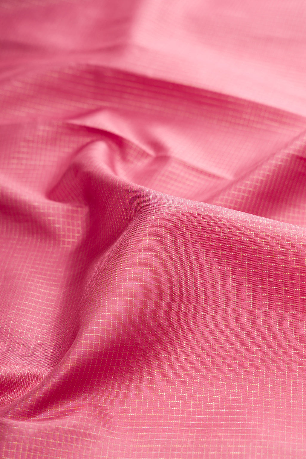 Close up of Pink Kanchipuram Silk Saree with Zari Brocade on the body and Embroidery Border.  displaying folds