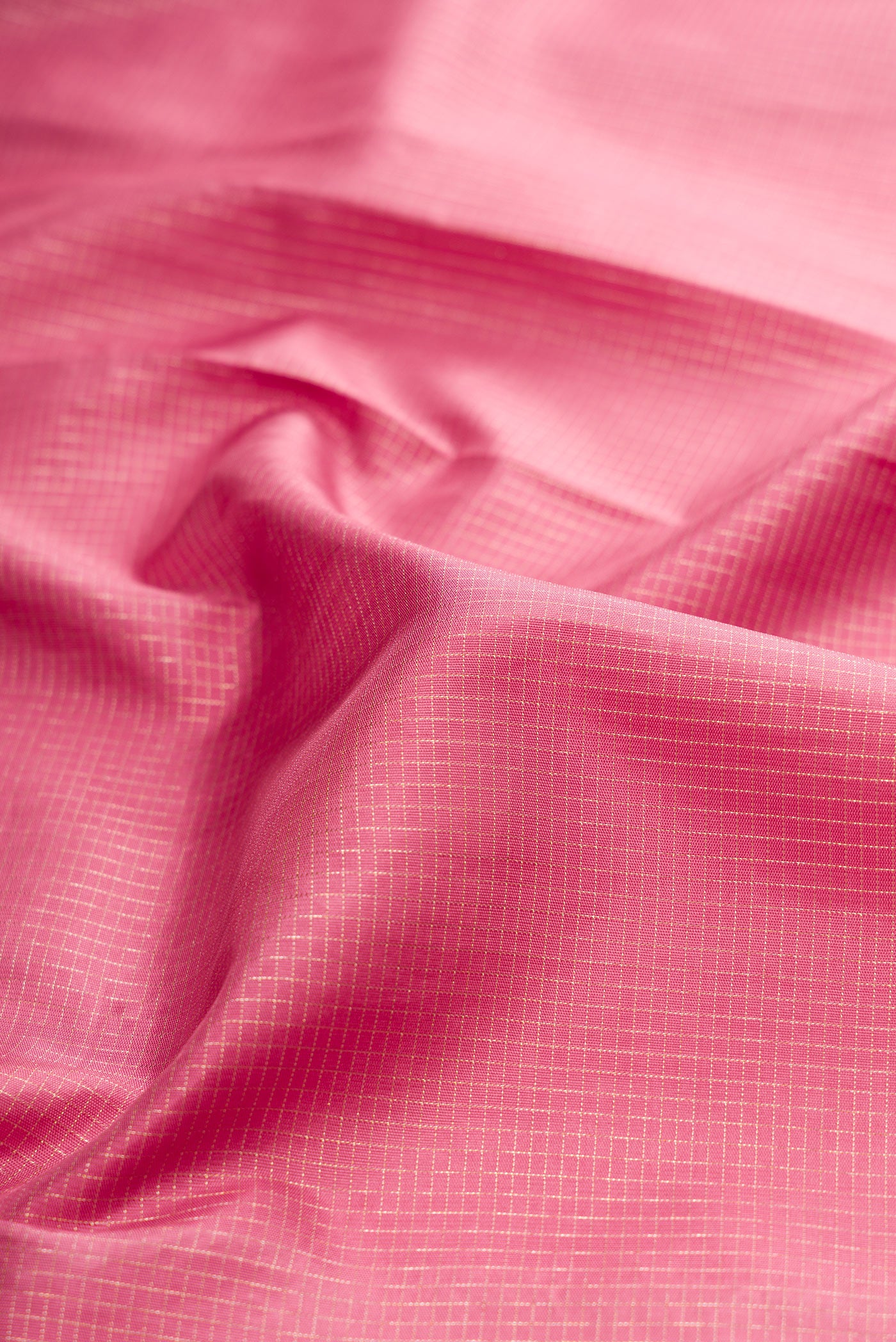 Close up of Pink Kanchipuram Silk Saree with Zari Brocade on the body and Embroidery Border.  displaying folds