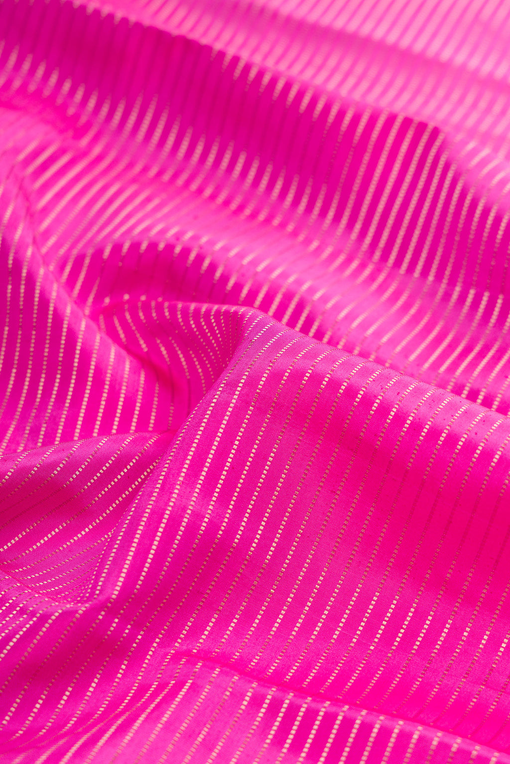 Close up of Rose pink Kanchipuram Silk Saree with Stripes on the body and Fancy Border.  displaying folds