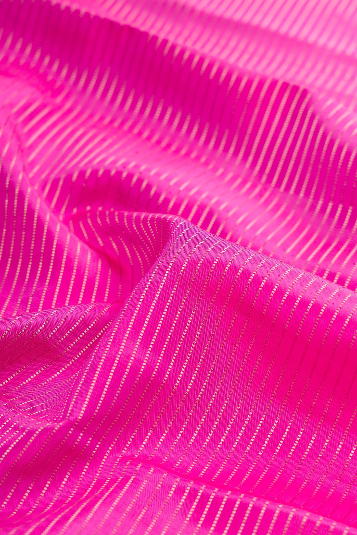 Close up of Rose pink Kanchipuram Silk Saree with Stripes on the body and Fancy Border.  displaying folds