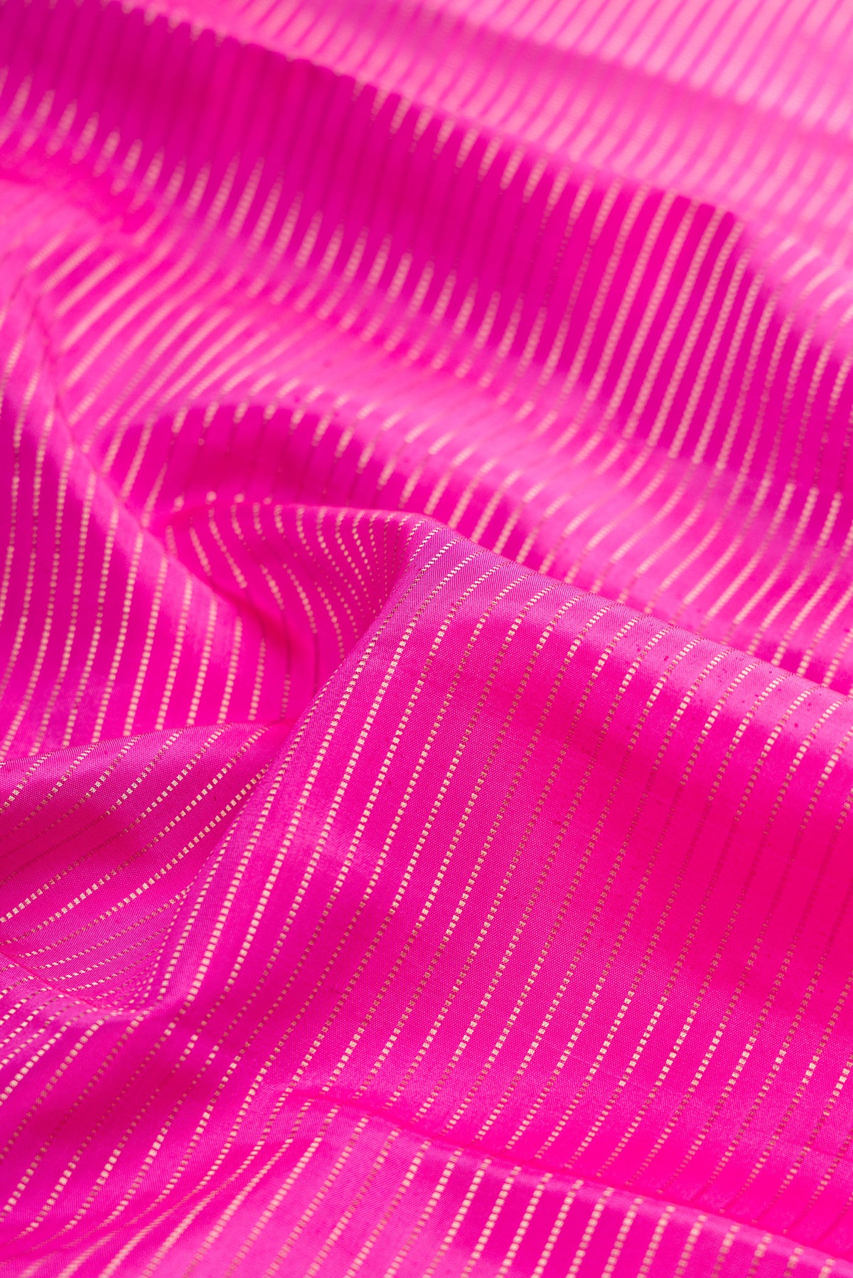 Close up of Rose pink Kanchipuram Silk Saree with Stripes on the body and Fancy Border.  displaying folds