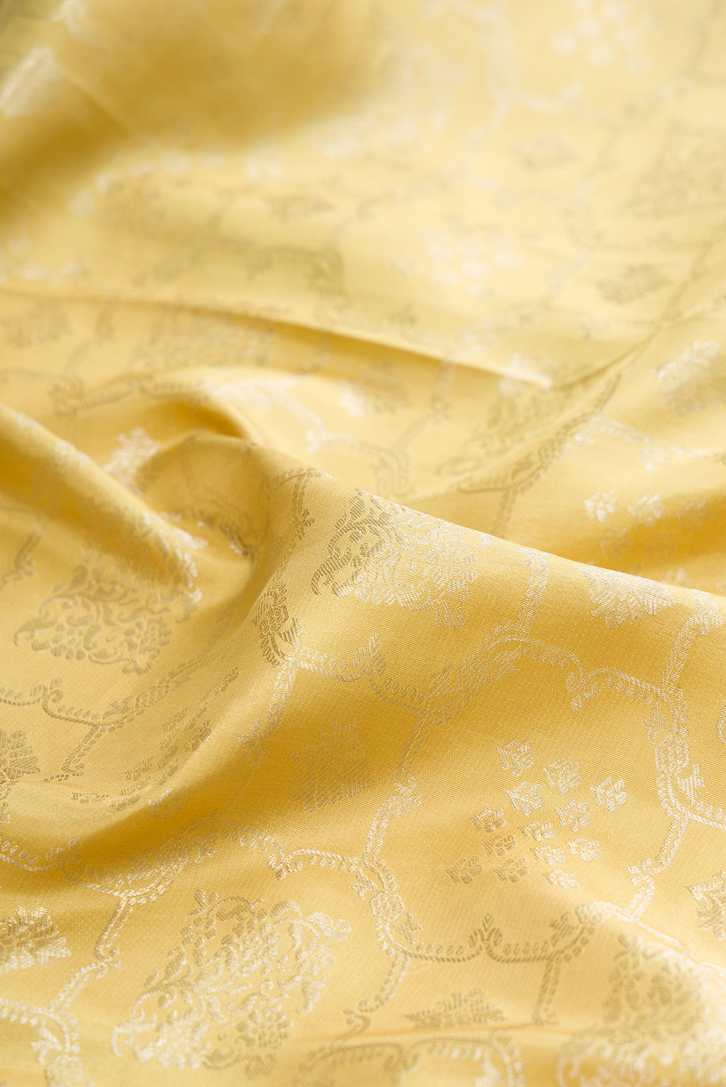Close up of Sandal Dual Tone Kanchipuram Silk Saree with Zari Brocade on the body and Embroidery Border.  displaying folds