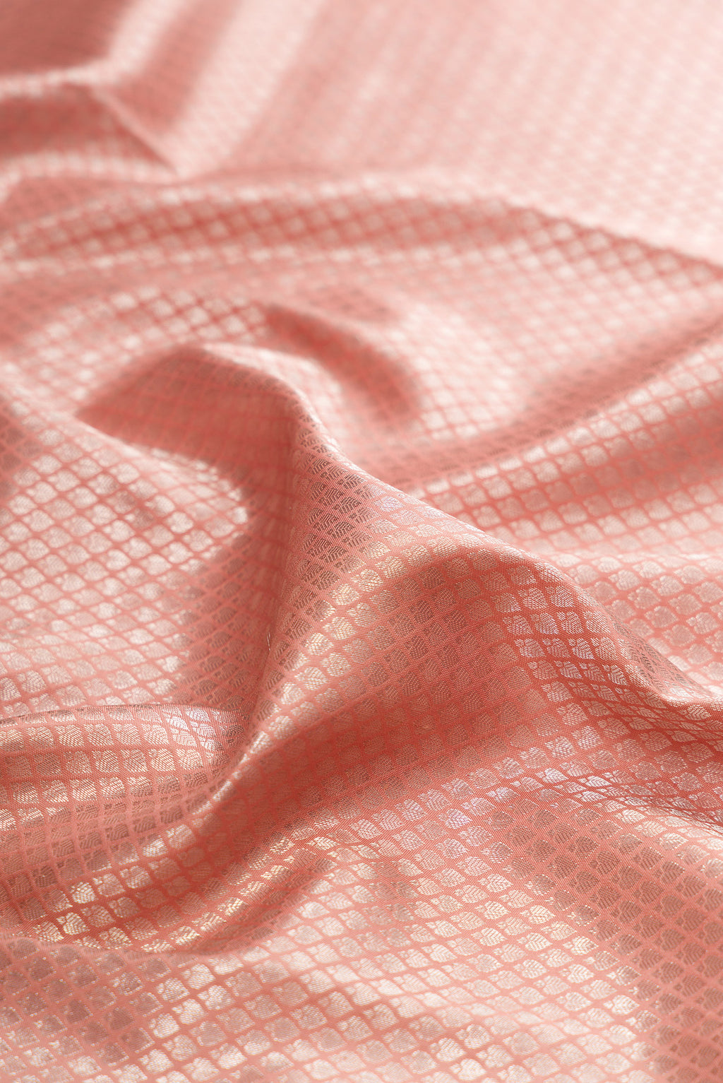 Close up of Brown Dual Tone Kanjivaram Silk Saree with Zari Brocade on the body and Embroidery Border.  displaying folds