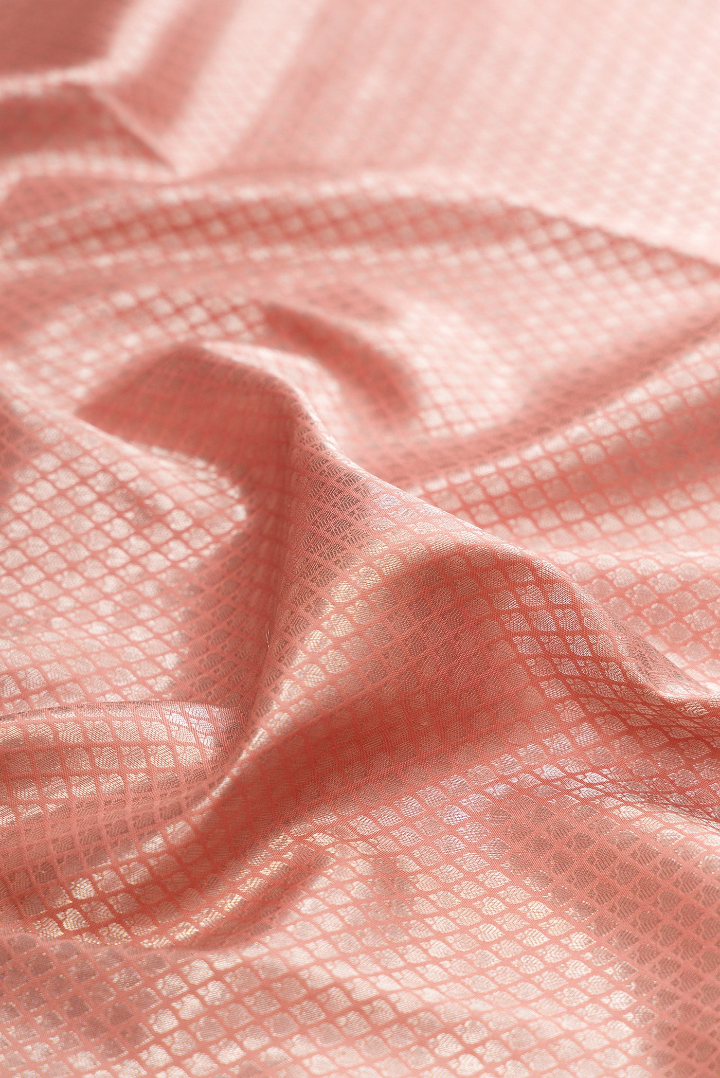 Close up of Brown Dual Tone Kanjivaram Silk Saree with Zari Brocade on the body and Embroidery Border.  displaying folds