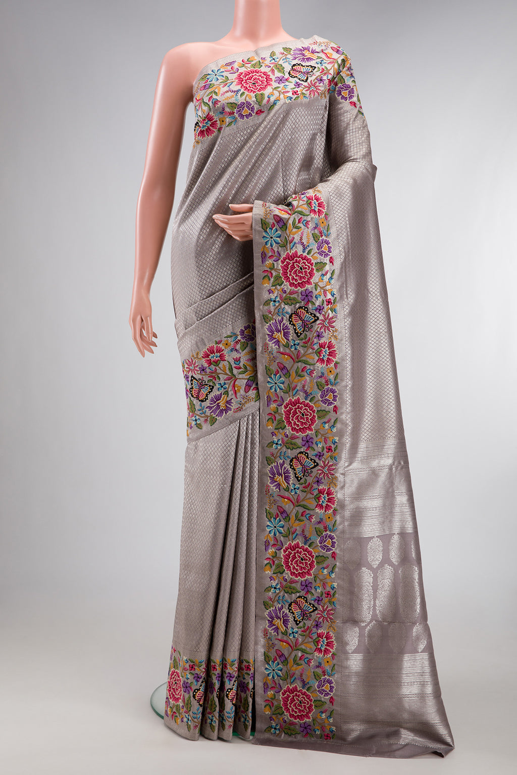 Grey Kanjivaram Silk Saree with Zari Brocade on the body and Embroidery Border.  displayed on a mannequin