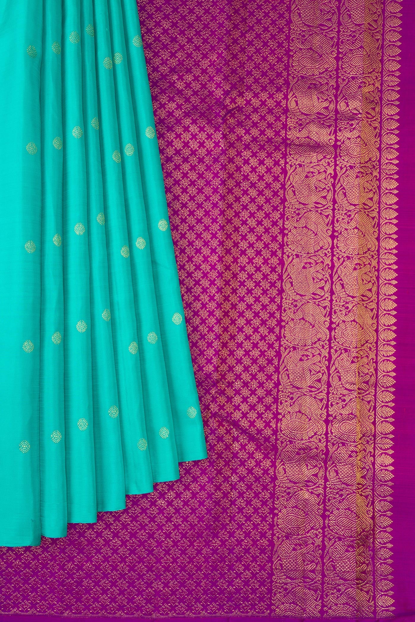 Pleats and pallu of Turquoise Kanchipuram Silk Saree with Zari Butta on the body and Without Border. 