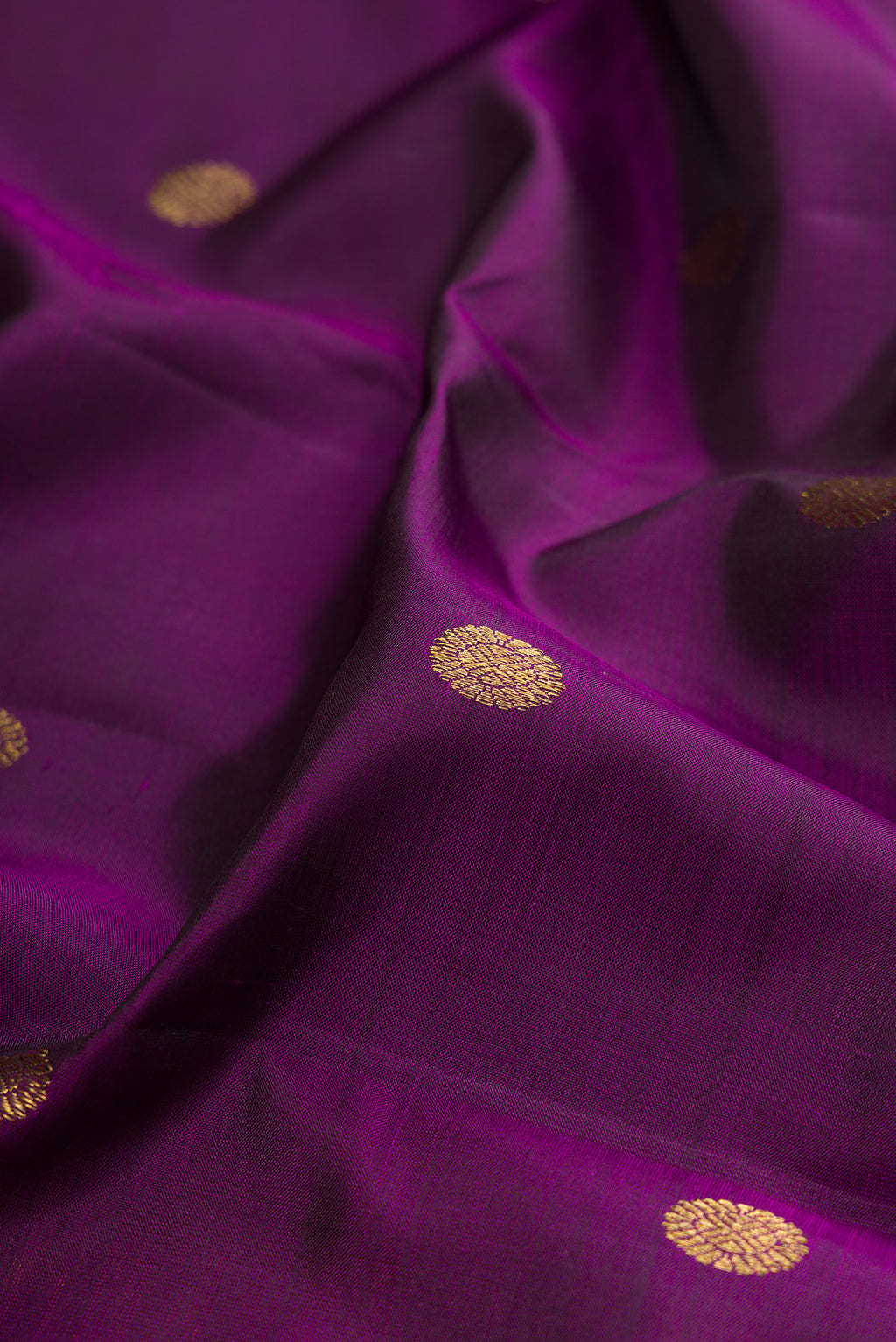 Close up of Violet Kanjivaram Silk Saree with Zari Butta on the body and Zari Border.  displaying folds