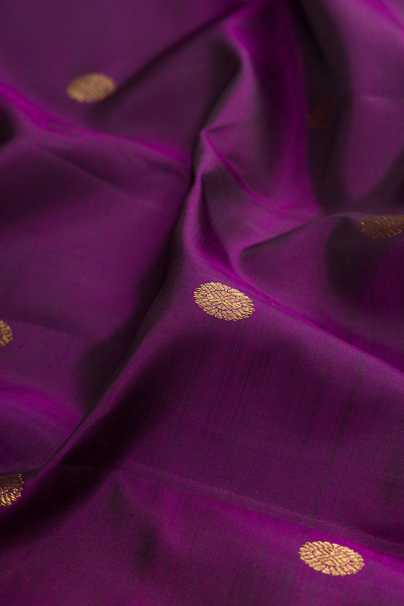 Close up of Violet Kanjivaram Silk Saree with Zari Butta on the body and Zari Border.  displaying folds
