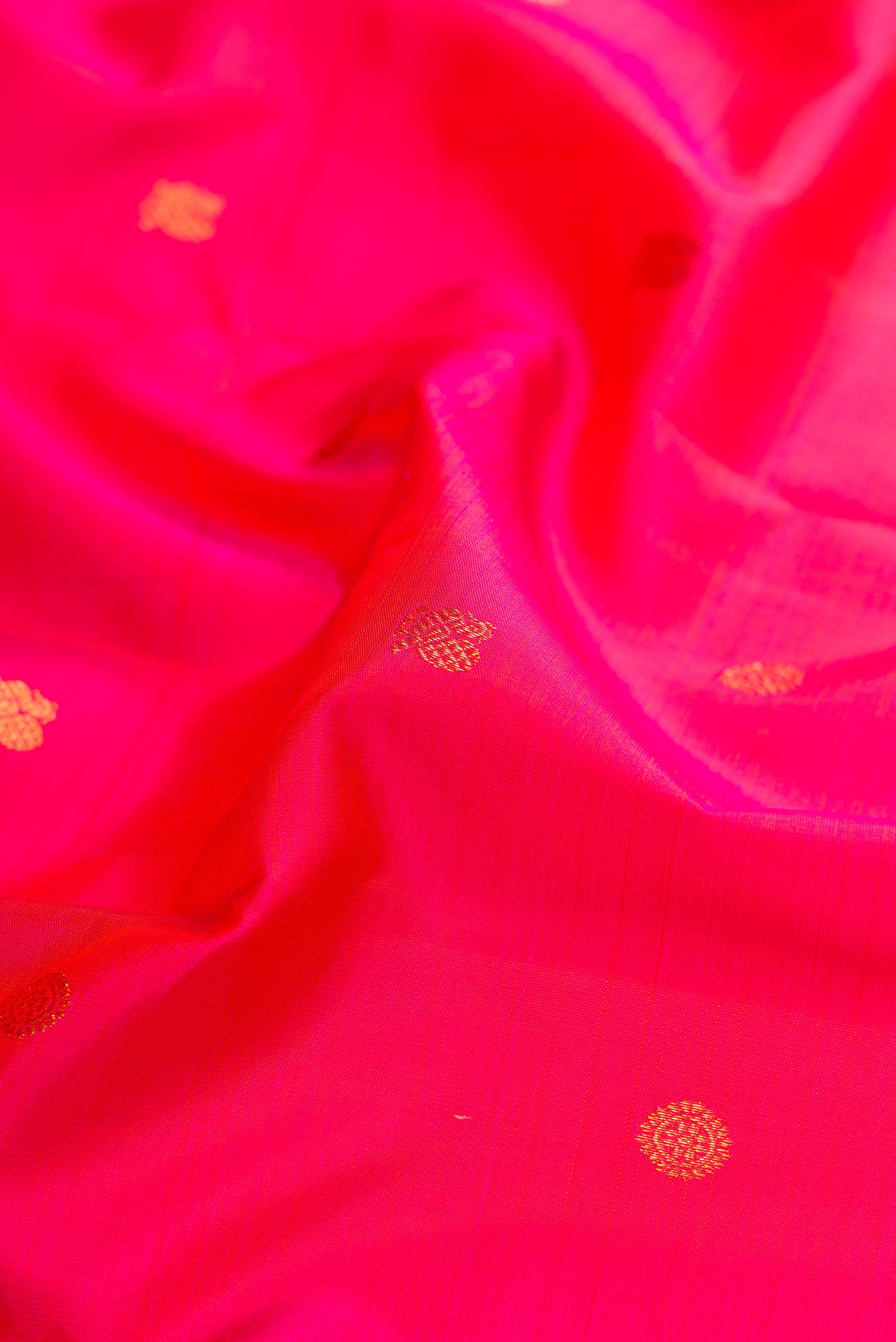 Close up of Pink Dual Tone Kanjivaram Silk Saree with Zari Butta on the body and Zari Border.  displaying folds