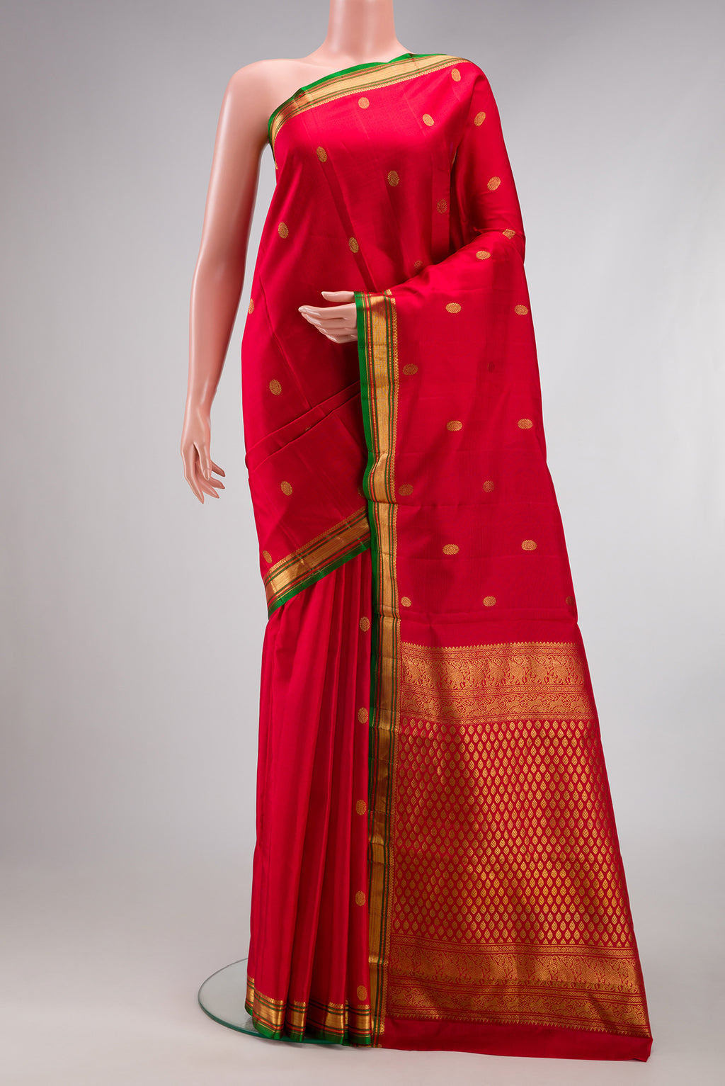 Red Kanjivaram Silk Saree with Zari Butta on the body and Zari Border.  displayed on a mannequin