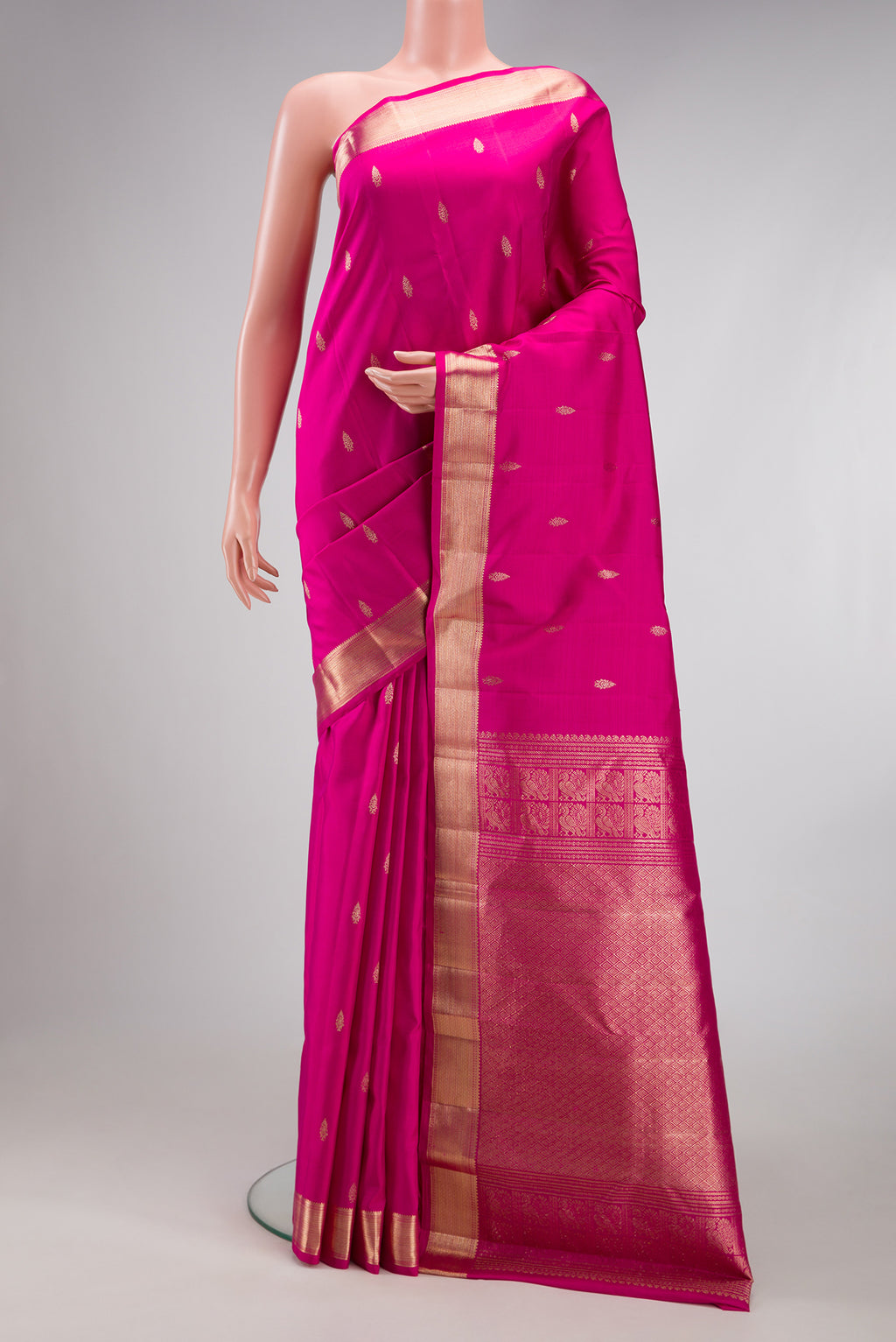 Pink Kanjivaram Silk Saree with Zari Butta on the body and Zari Border.  displayed on a mannequin