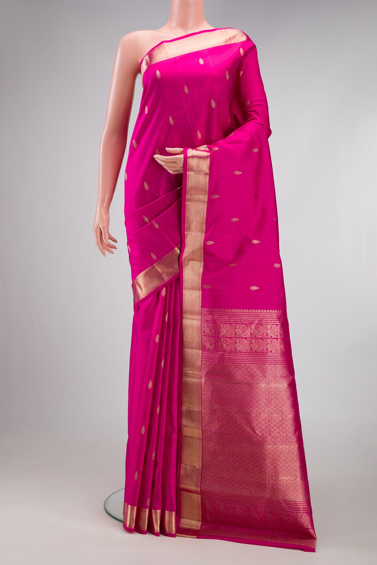 Pink Kanjivaram Silk Saree with Zari Butta on the body and Zari Border.  displayed on a mannequin