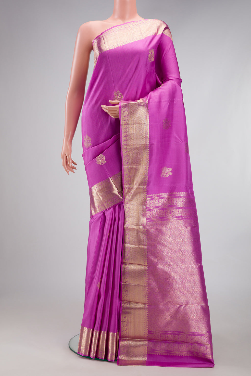 Lavender Kanjivaram Silk Saree with Zari Butta on the body and Zari Border.  displayed on a mannequin