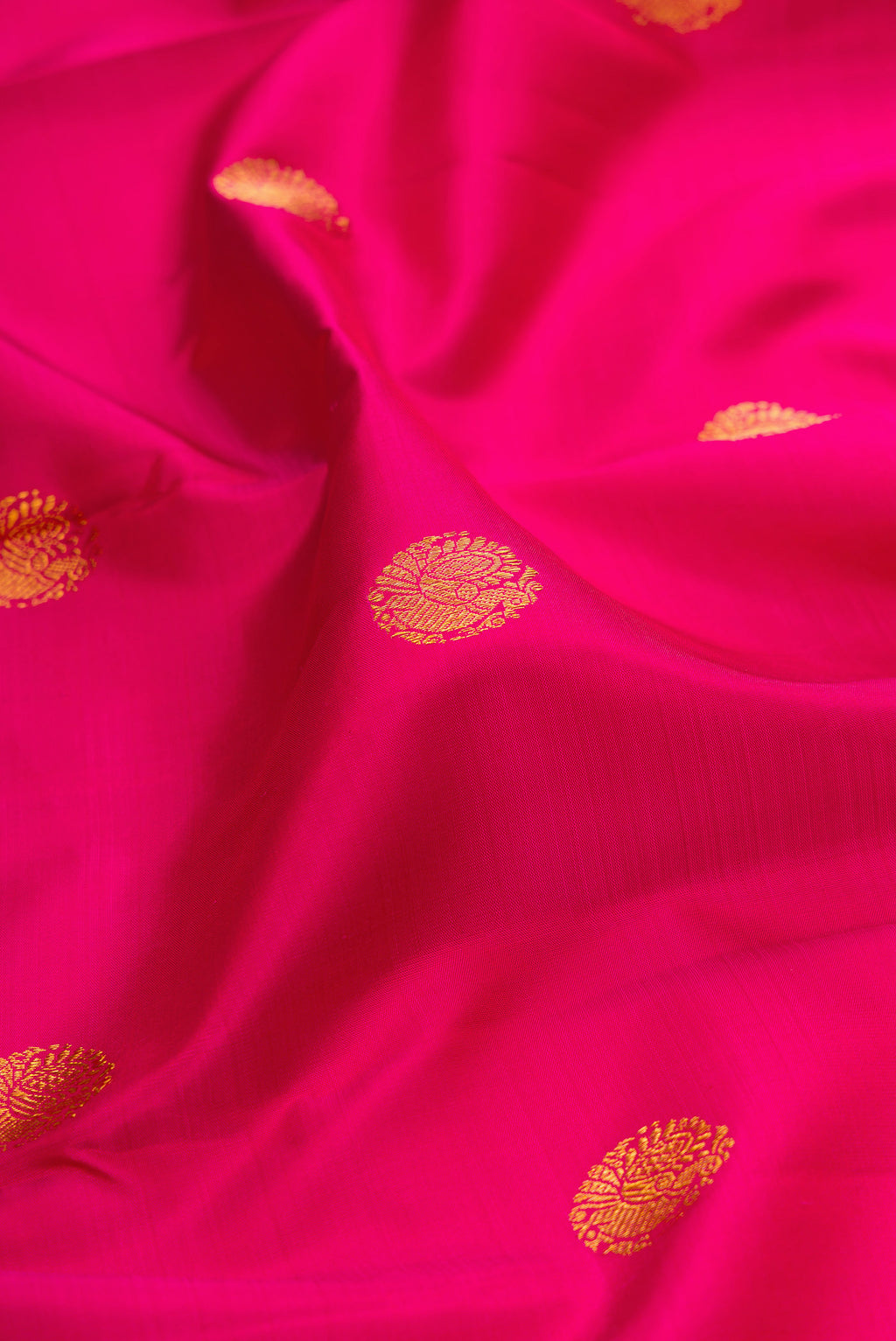 Close up of Pink Kanjivaram Silk Saree with Zari Butta on the body and Zari Border.  displaying folds