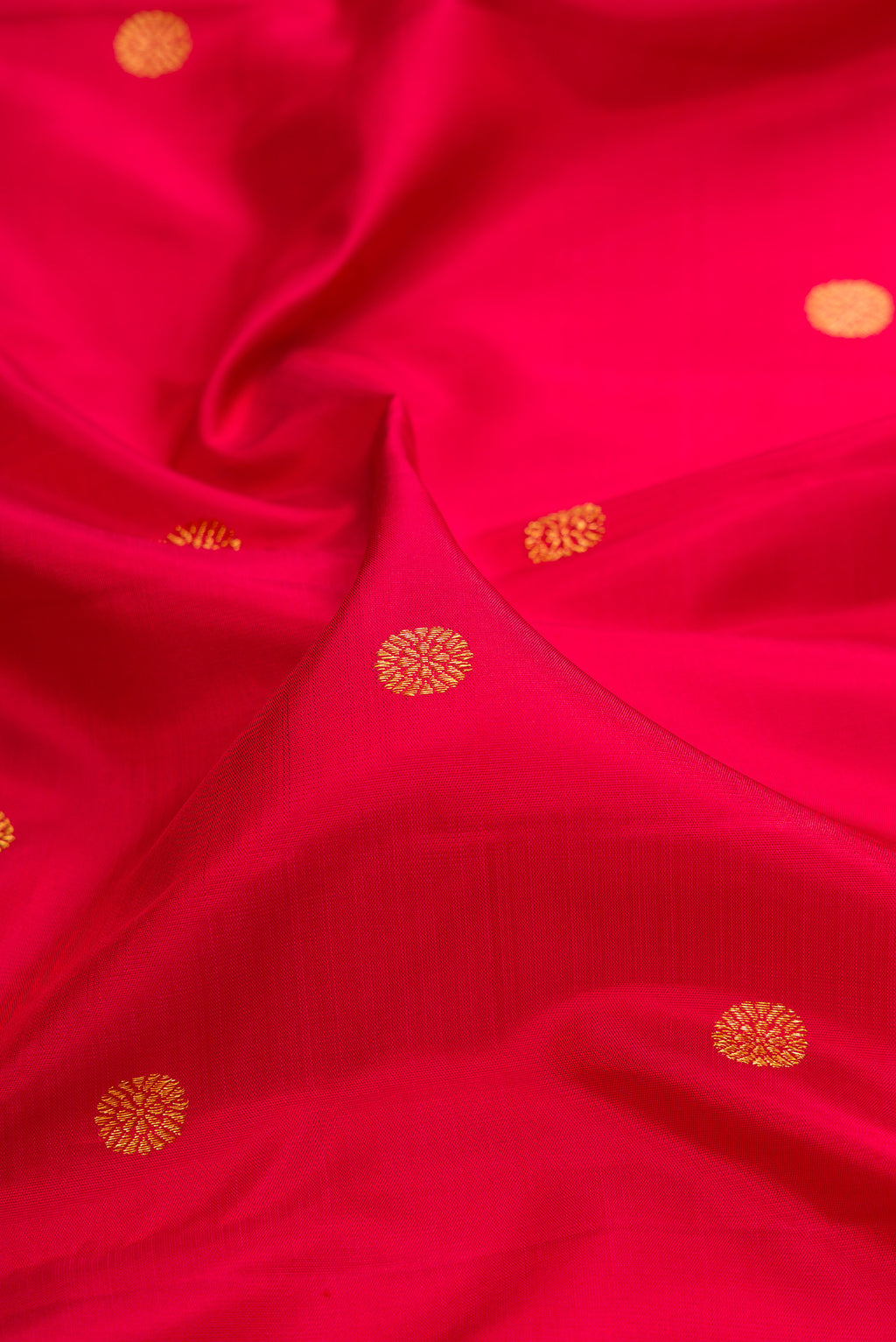 Close up of Red Kanjivaram Silk Saree with Zari Butta on the body and Temple Border.  displaying folds