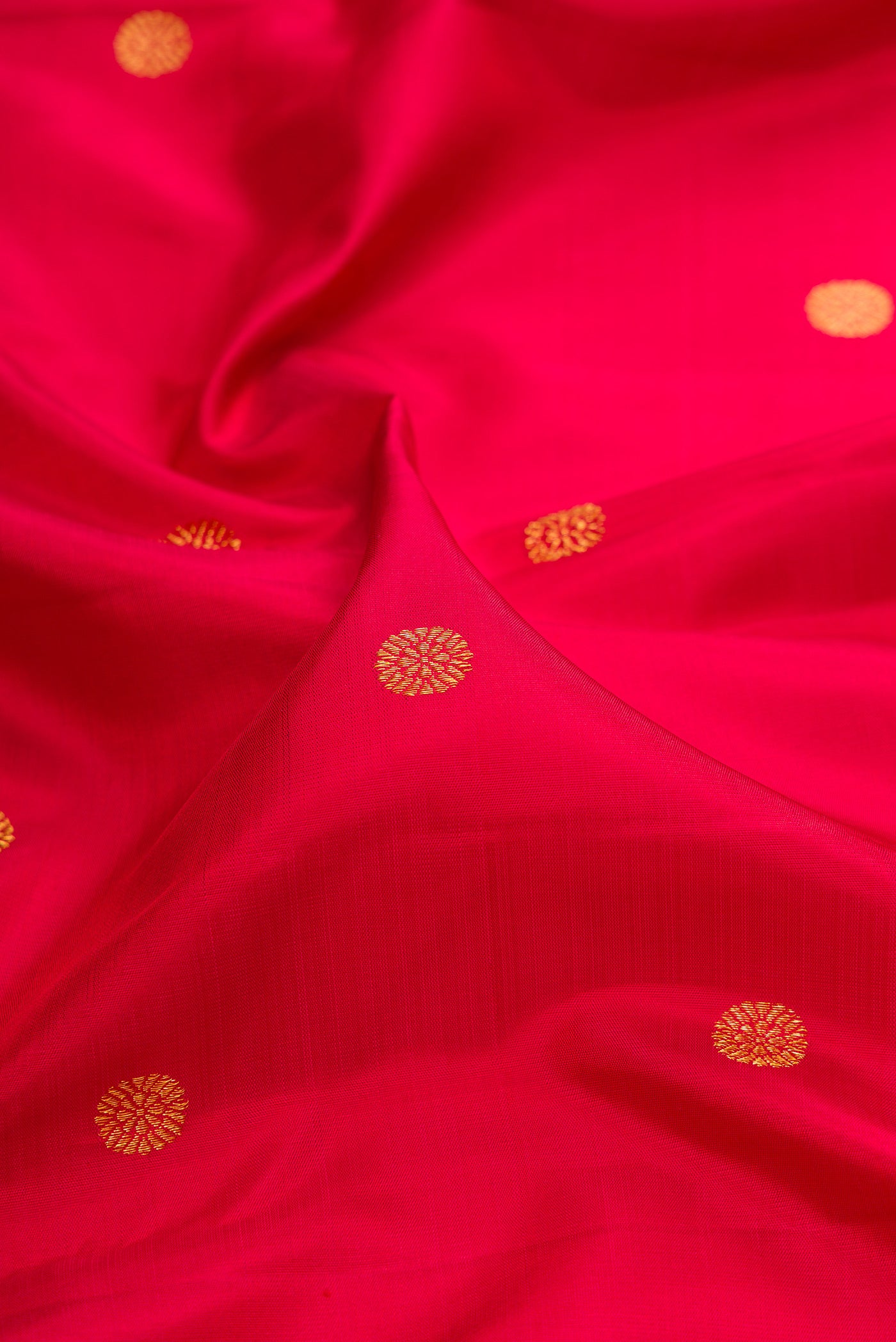 Close up of Red Kanjivaram Silk Saree with Zari Butta on the body and Temple Border.  displaying folds