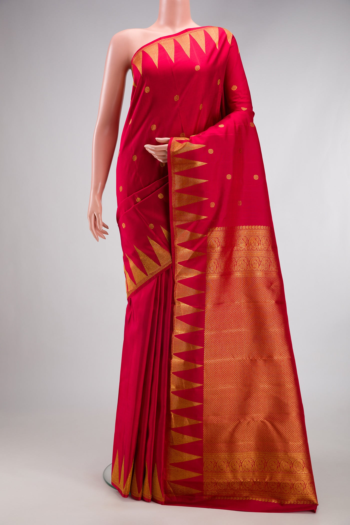 Red Kanjivaram Silk Saree with Zari Butta on the body and Temple Border.  displayed on a mannequin