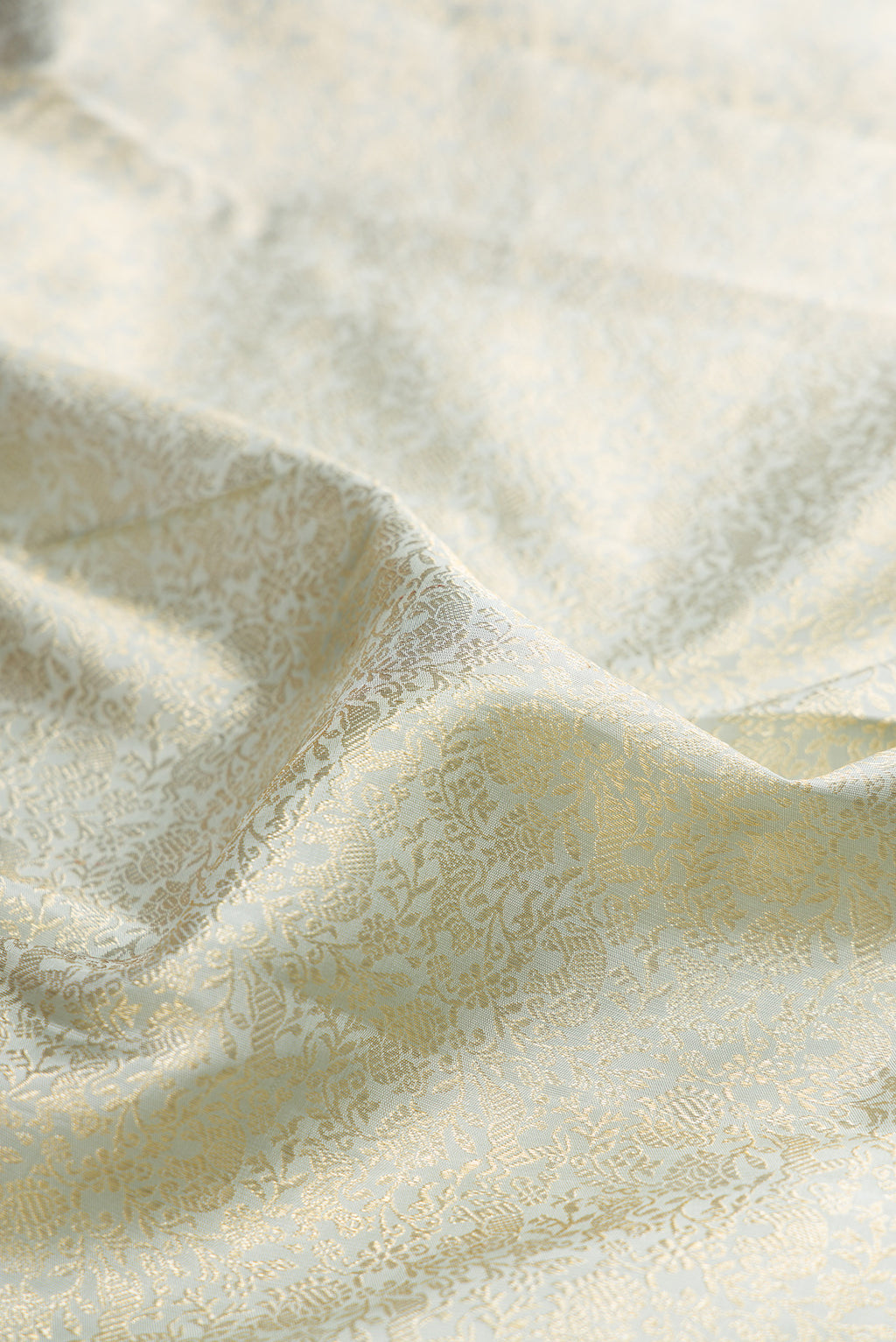 Close up of Grey Kanchipuram Silk Saree with Zari Brocade on the body and Zari Border.  displaying folds