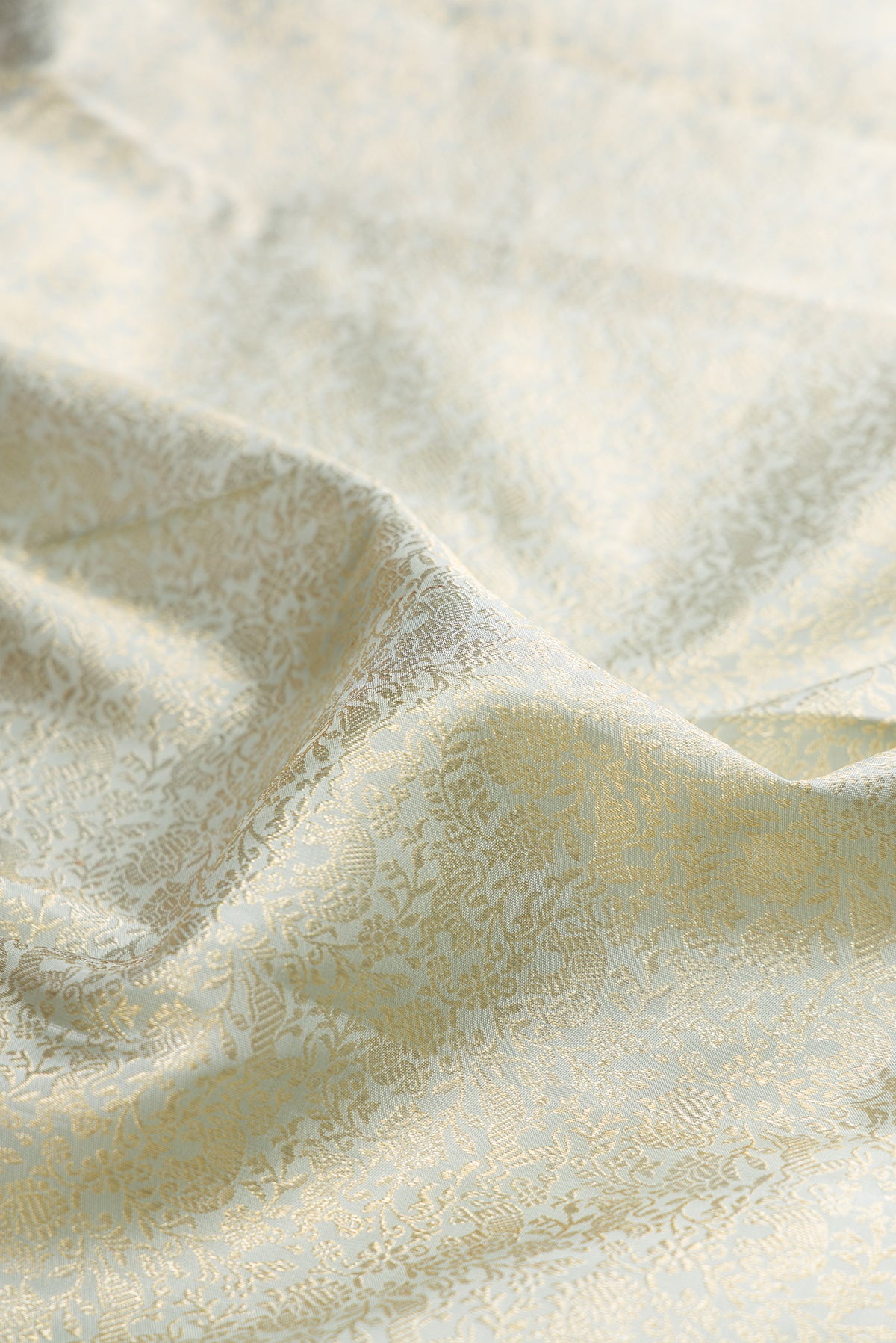 Close up of Grey Kanchipuram Silk Saree with Zari Brocade on the body and Zari Border.  displaying folds